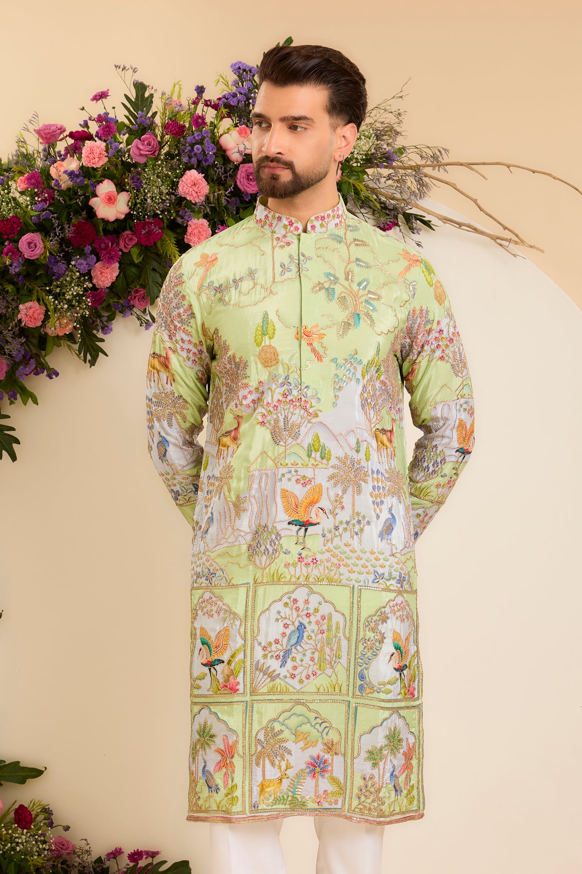 A Vibrant green Crepe Kurta Richly Embroidered with Wildlife