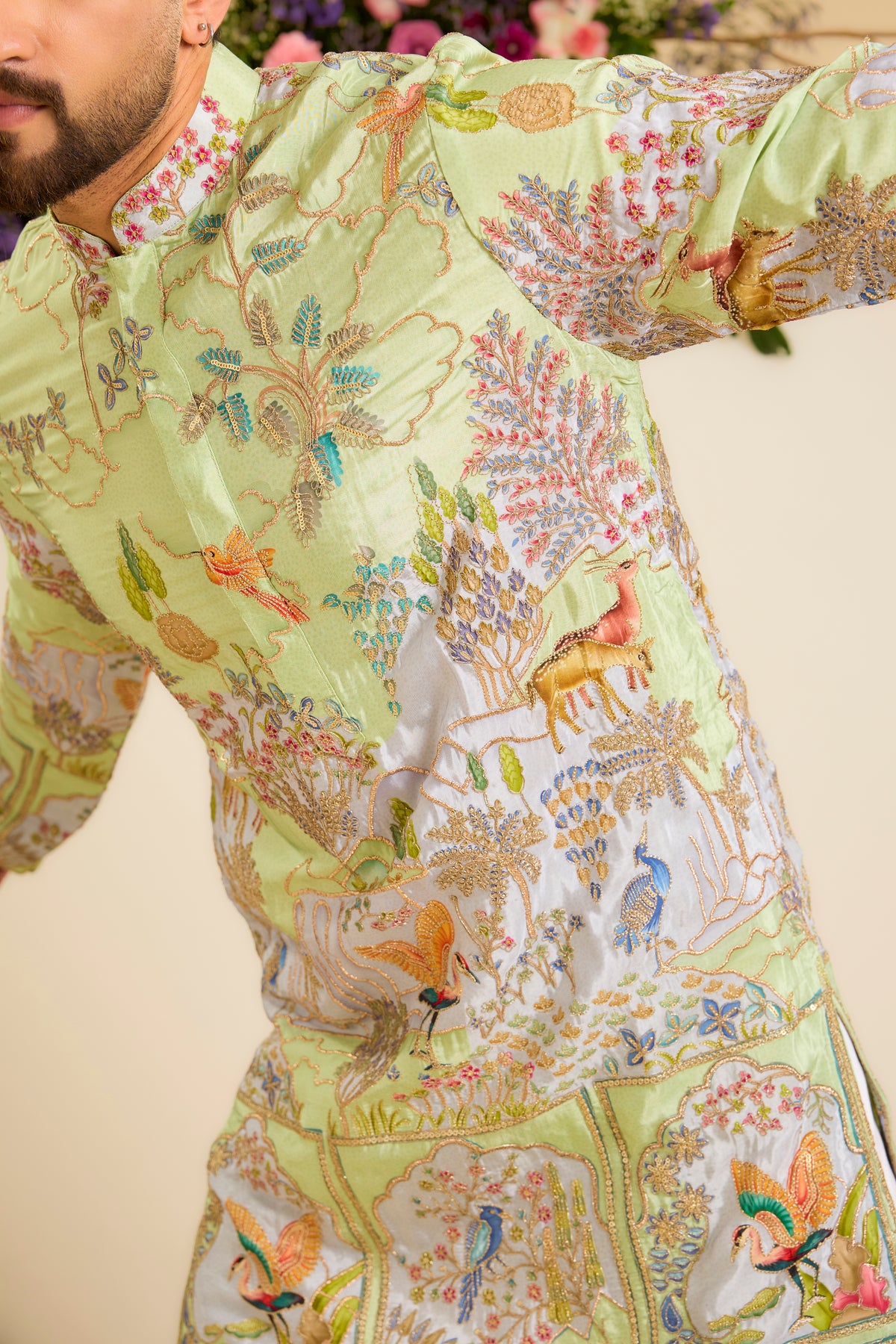 A Vibrant green Crepe Kurta Richly Embroidered with Wildlife