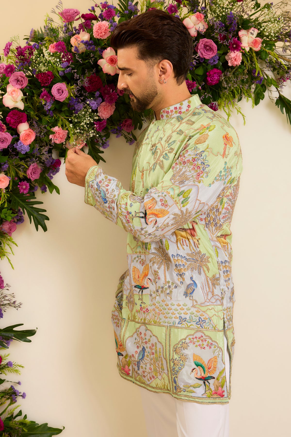 A Vibrant green Crepe short Kurta Richly Embroidered with Wildlife