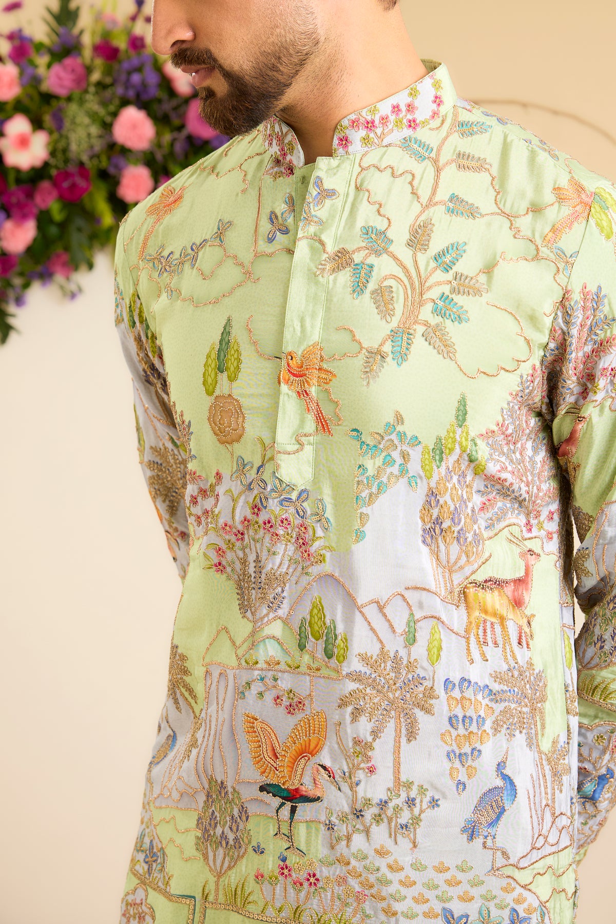 A Vibrant green Crepe short Kurta Richly Embroidered with Wildlife
