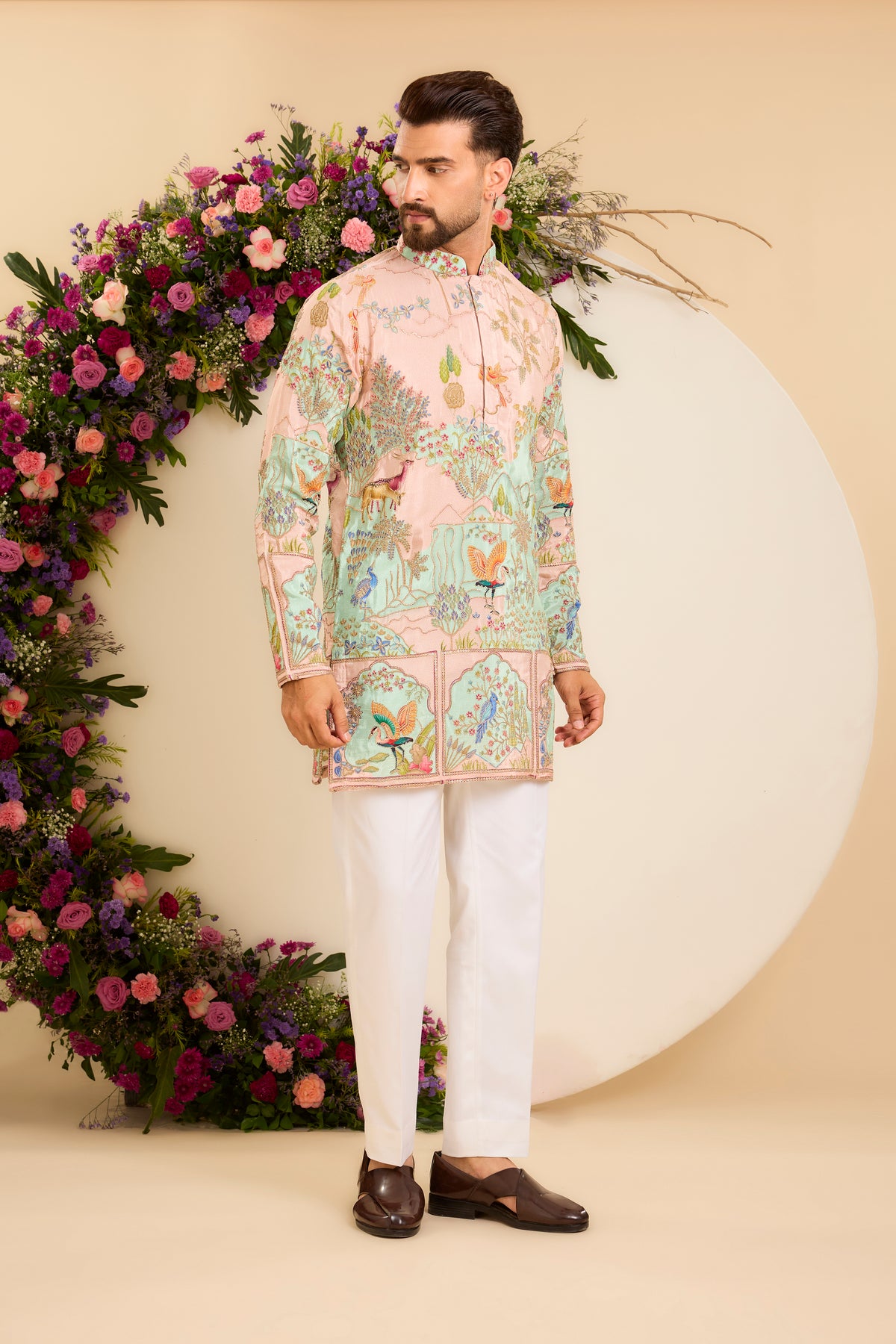 A Vibrant green Crepe short Kurta Richly Embroidered with Wildlife