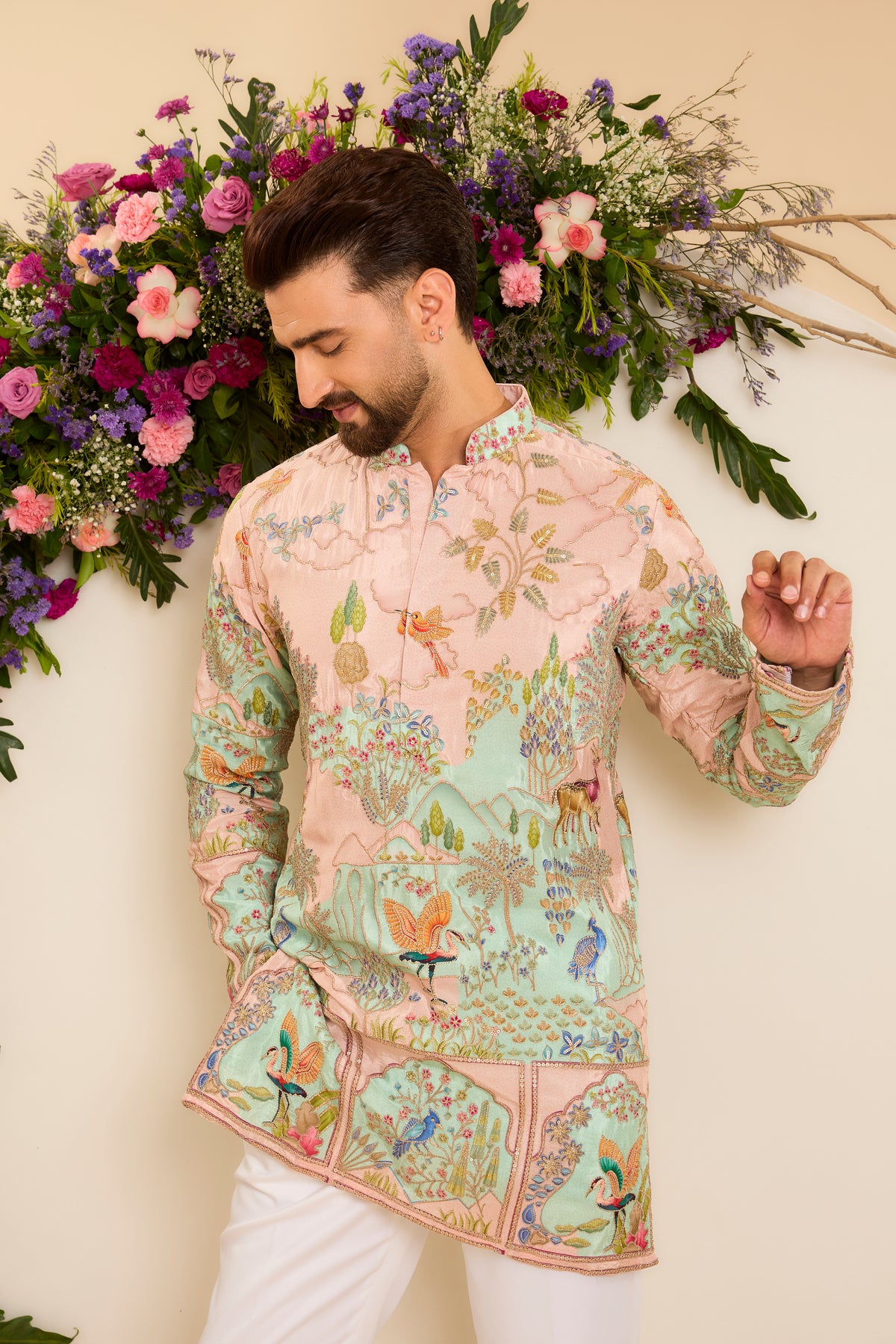 A Vibrant green Crepe short Kurta Richly Embroidered with Wildlife