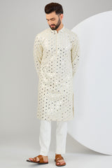 Cream mirror-work kurta with intricate gold sequin highlighting.&nbsp;