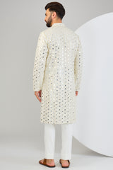 Cream mirror-work kurta with intricate gold sequin highlighting.&nbsp;