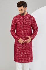 Signature red mirror-work kurta.