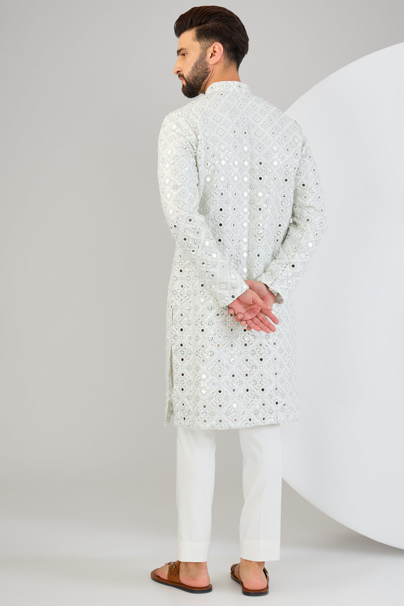 Signature mirror-work kurta with sea-green and ivory thread-work.