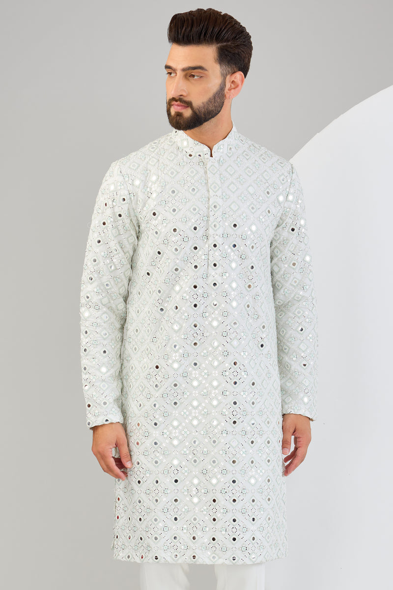 Signature mirror-work kurta with sea-green and ivory thread-work.