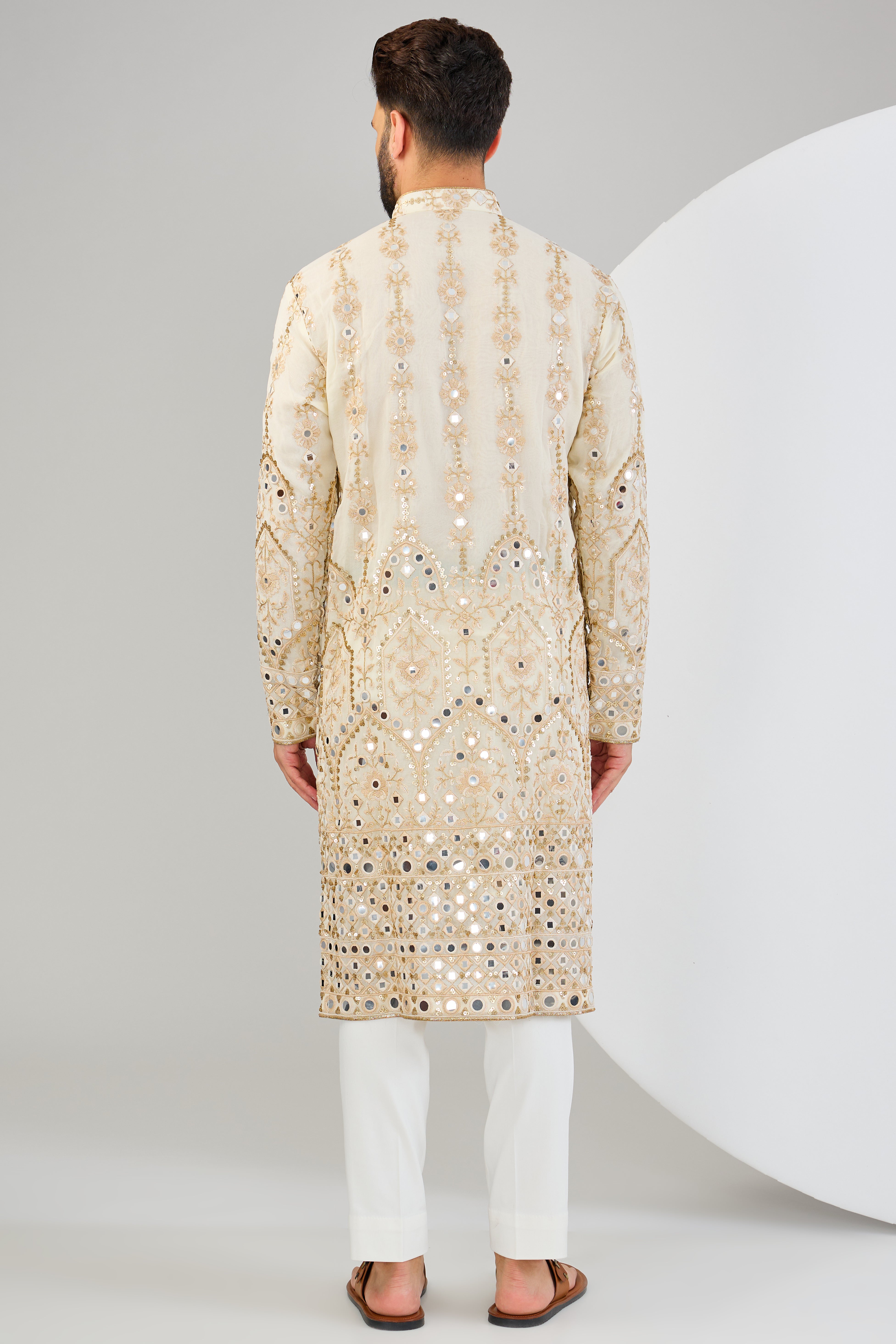 Cream mirror work kurta with detailed neckline and ghera with gold zari highlighting. - kasbahmen