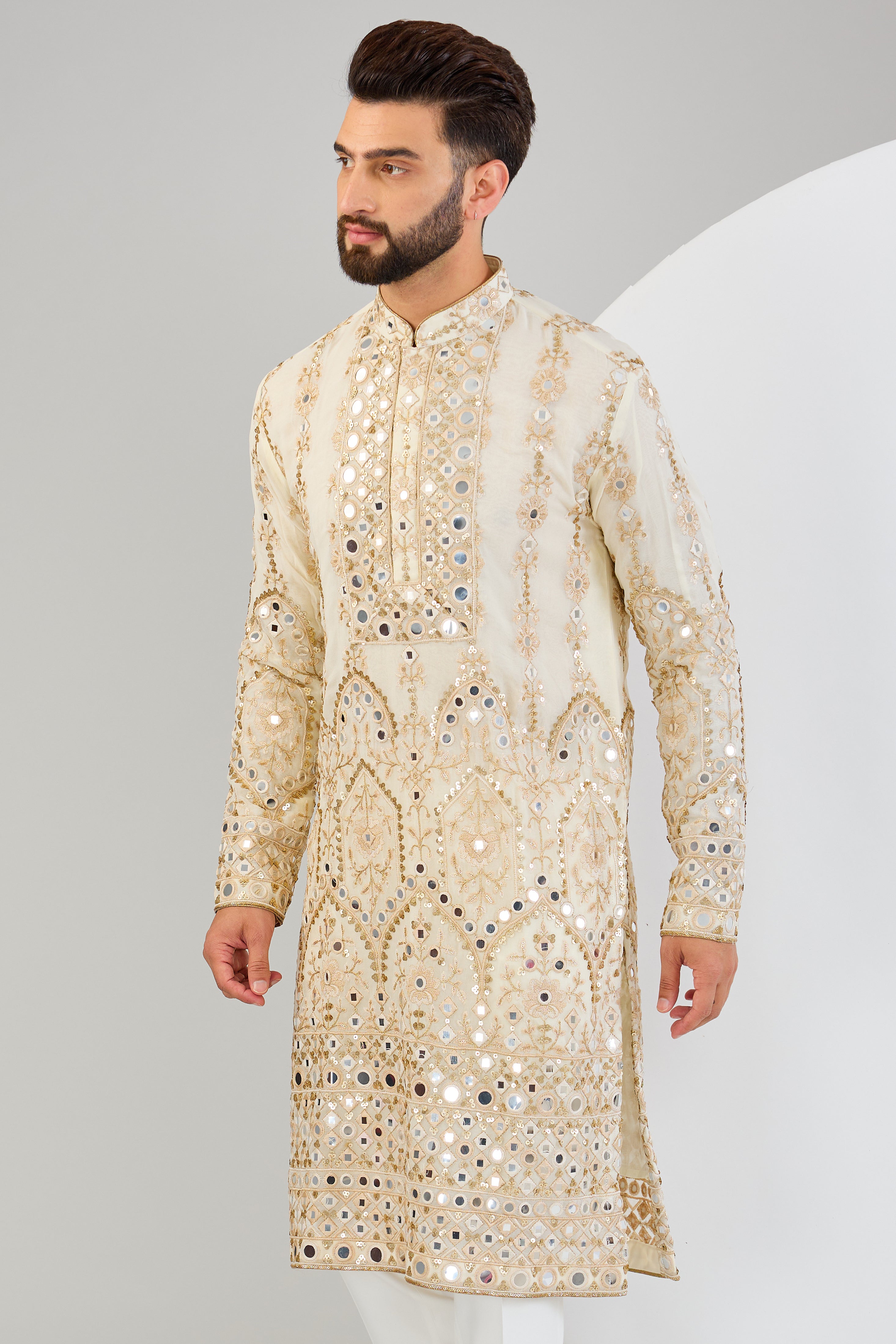 Cream mirror work kurta with detailed neckline and ghera with gold zari highlighting. - kasbahmen