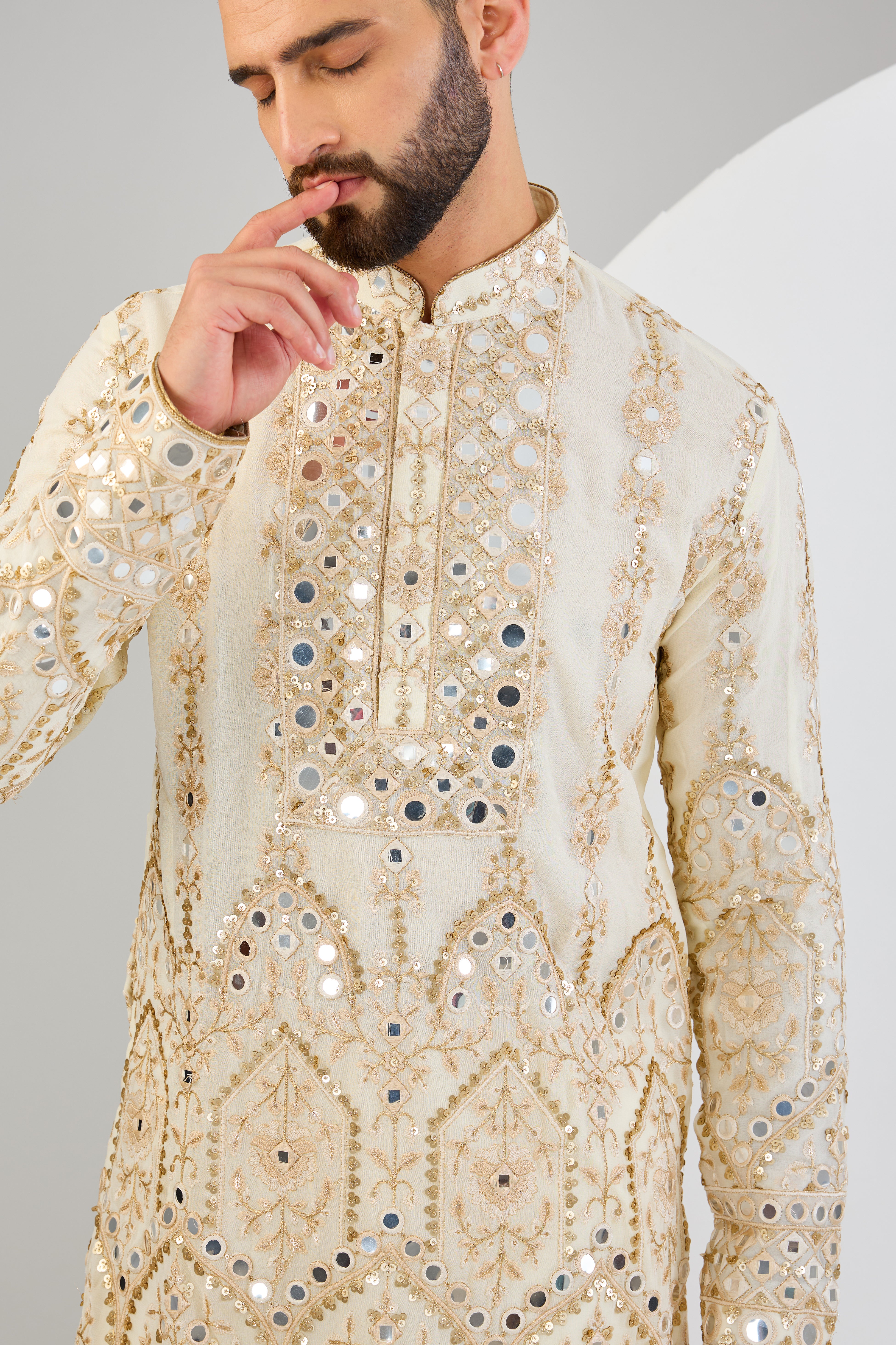 Cream mirror work kurta with detailed neckline and ghera with gold zari highlighting. - kasbahmen