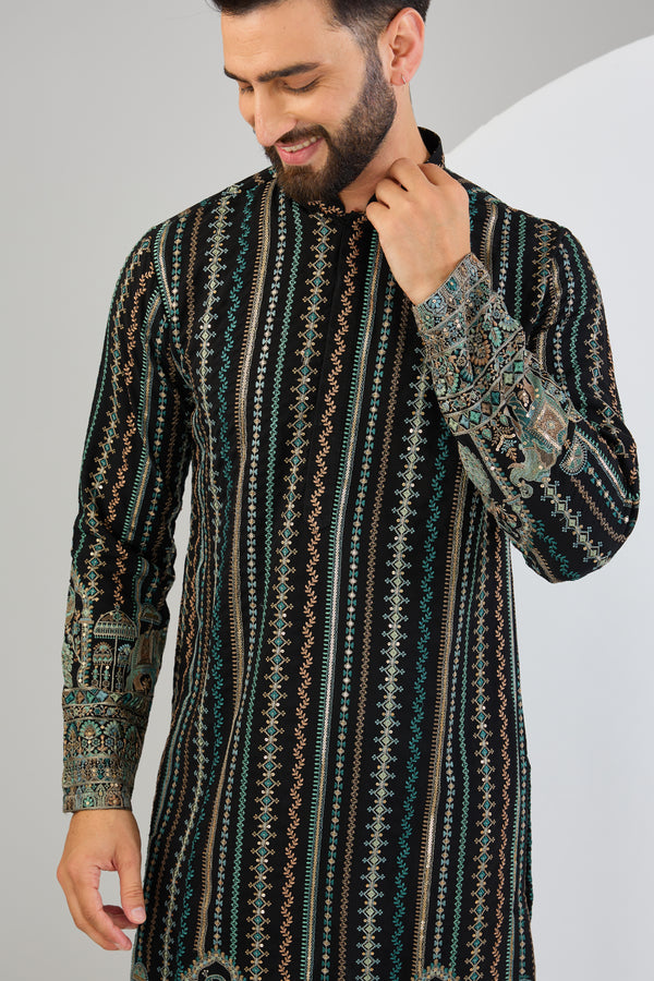 Black chikankari kurta with intricate multi-thread work and detailed kalamkari work on the ghera.