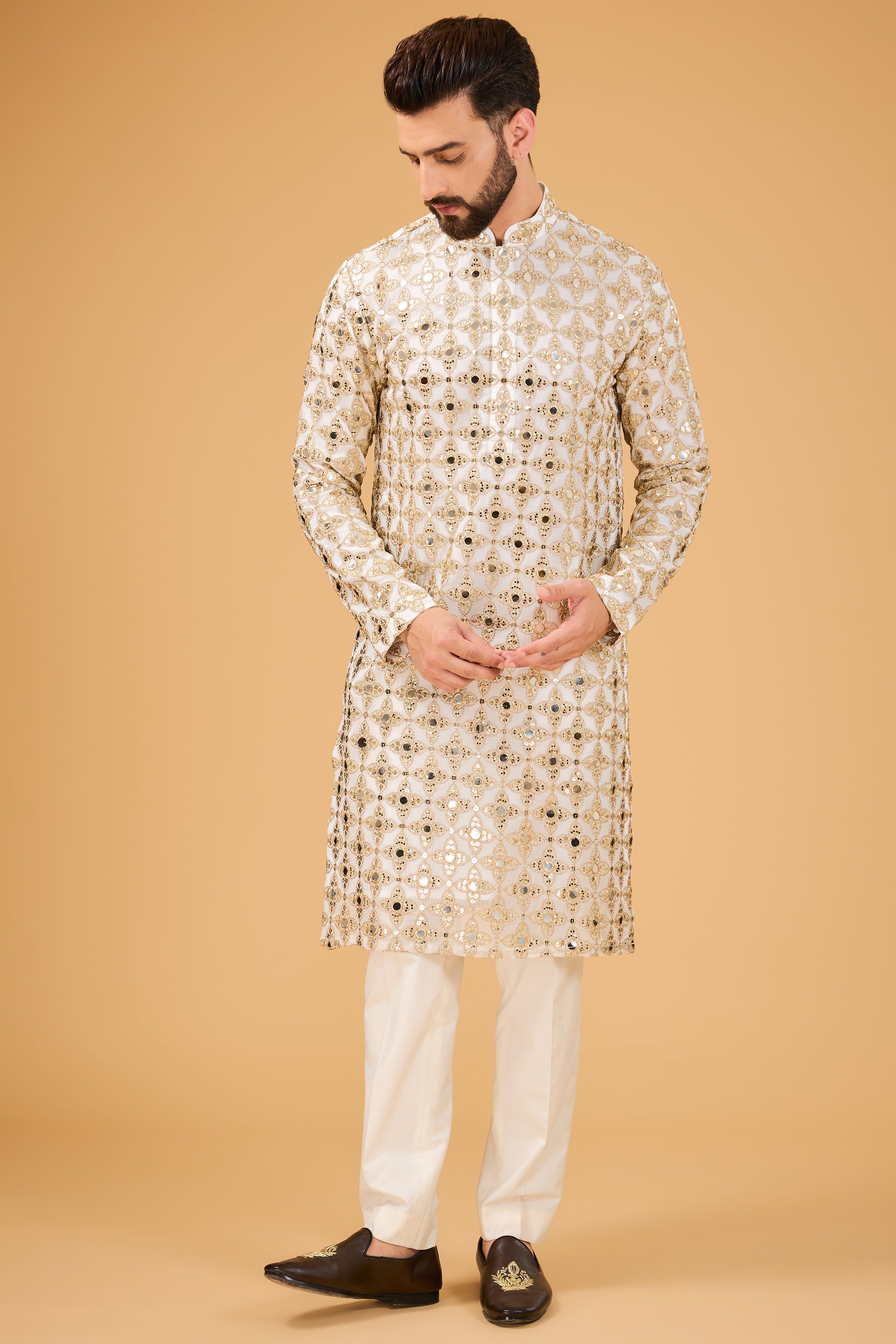 Signature mirror-work kurta with detailed golden zari embroidery. - kasbahmen