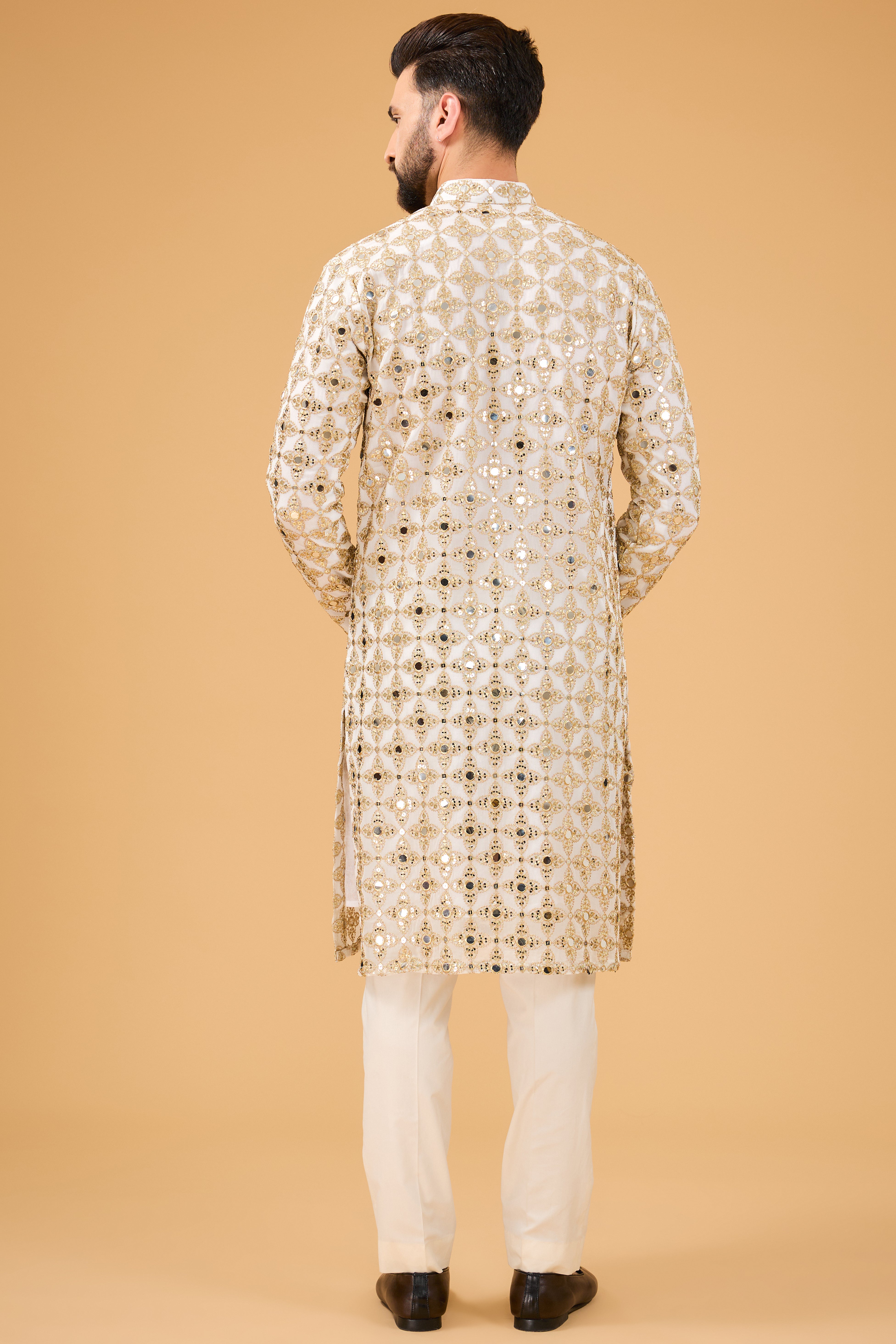 Signature mirror-work kurta with detailed golden zari embroidery. - kasbahmen