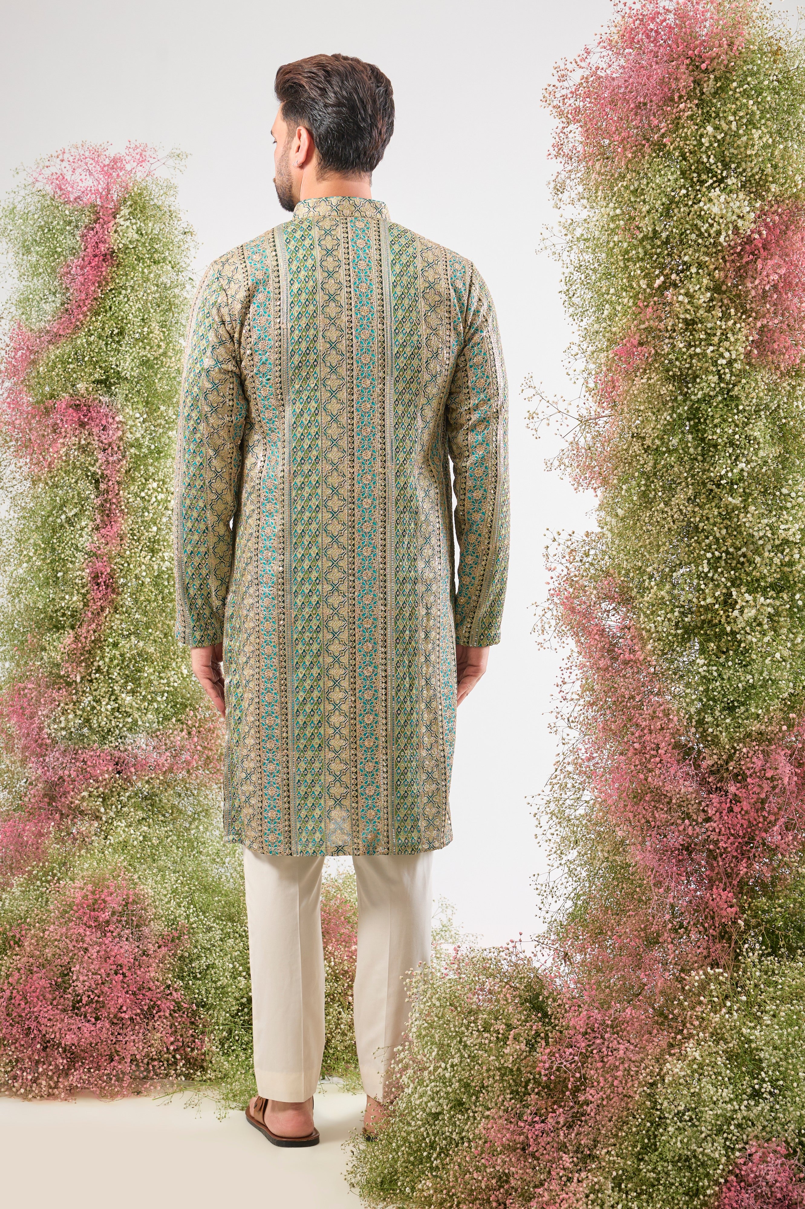 The vibrant Turquoise base of this kurta comes alive with Heavy Zari Work and the detailed sparkle of Intricate Sequin Embroidery.