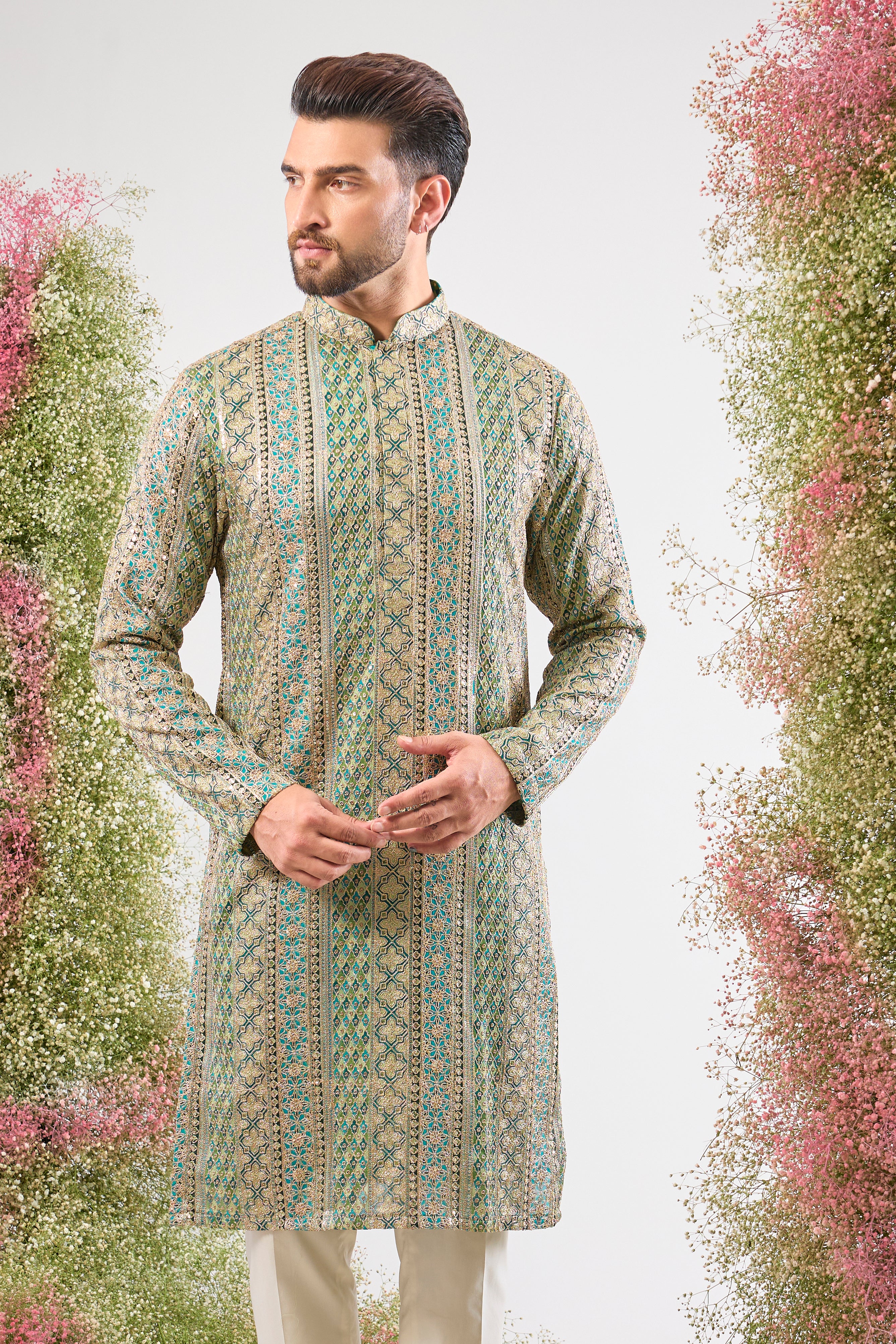 The vibrant Turquoise base of this kurta comes alive with Heavy Zari Work and the detailed sparkle of Intricate Sequin Embroidery.