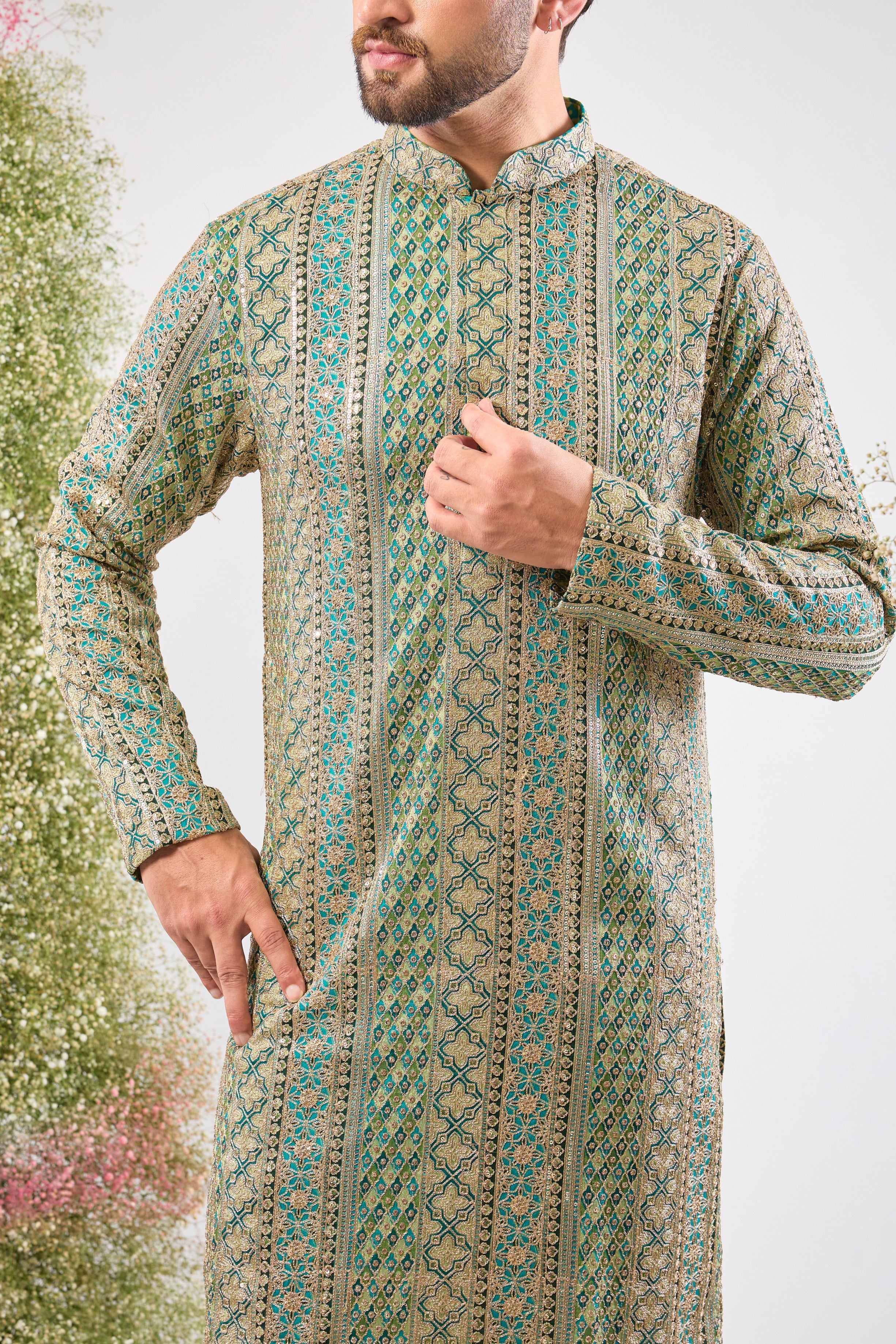 The vibrant Turquoise base of this kurta comes alive with Heavy Zari Work and the detailed sparkle of Intricate Sequin Embroidery.