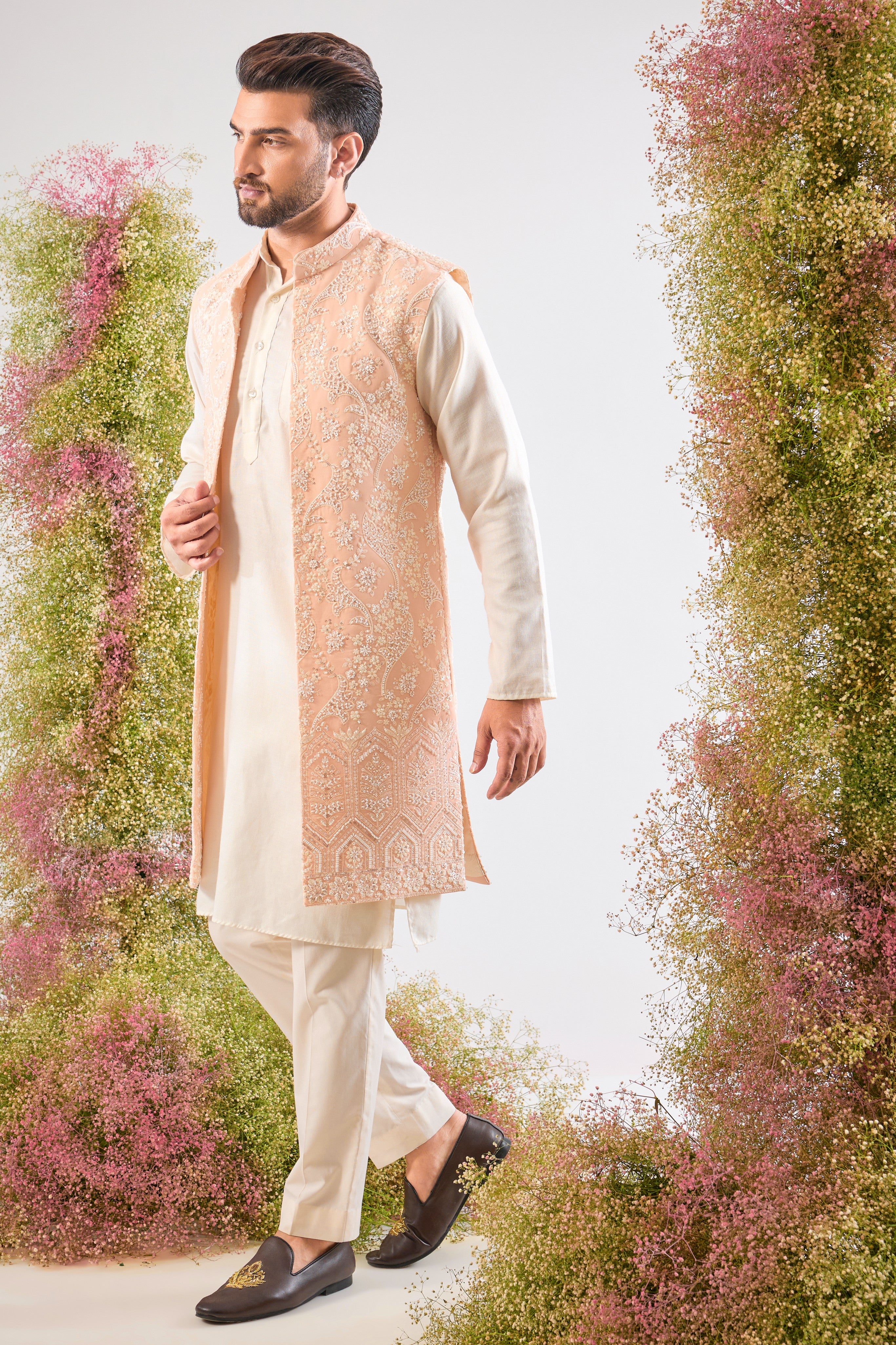 This stunning Pink Long Open Jacket is lavishly detailed with Intricate Hand Embroidered White Cut Dana work that catches the light beautifully.