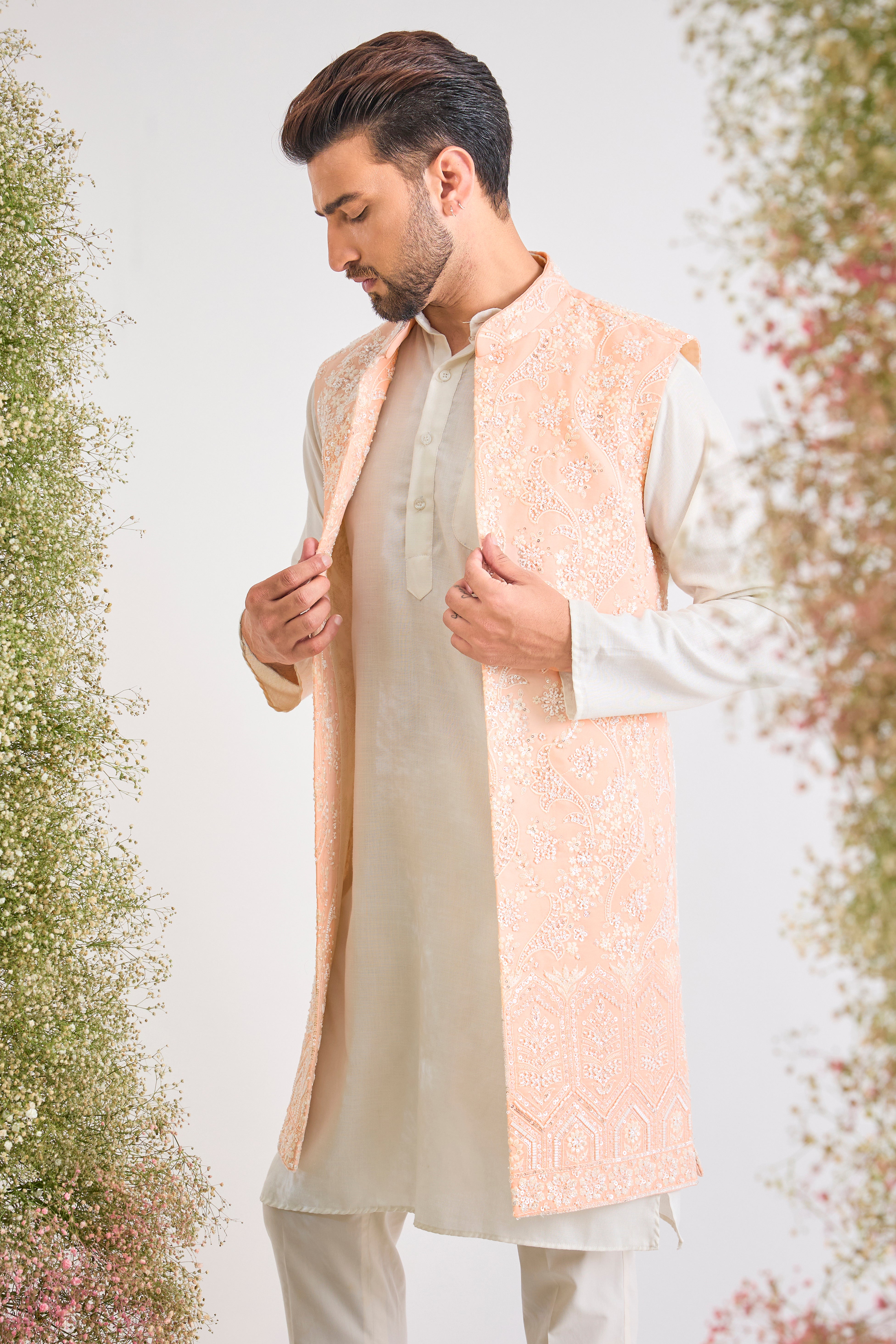 This stunning Pink Long Open Jacket is lavishly detailed with Intricate Hand Embroidered White Cut Dana work that catches the light beautifully.