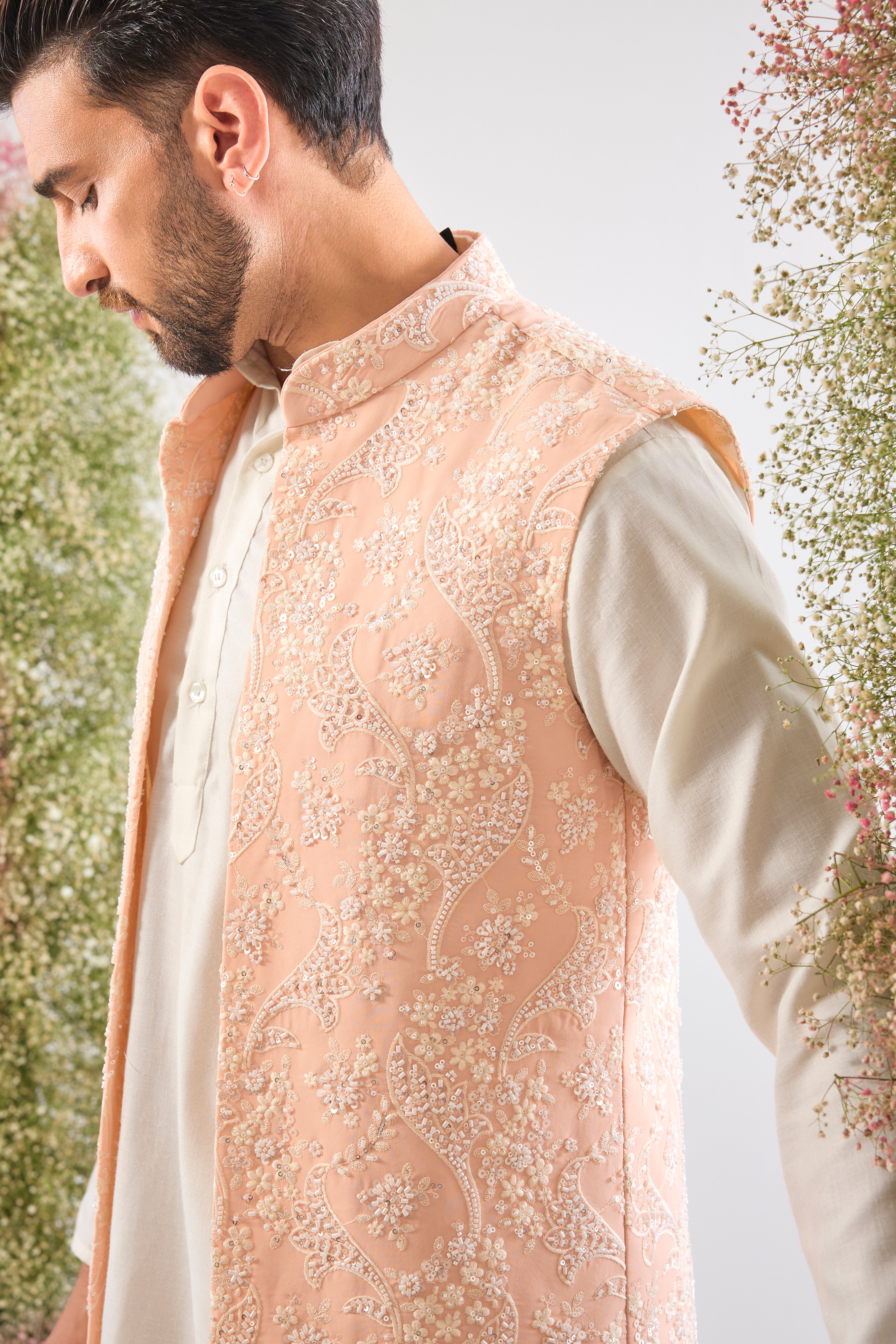 This stunning Pink Long Open Jacket is lavishly detailed with Intricate Hand Embroidered White Cut Dana work that catches the light beautifully.