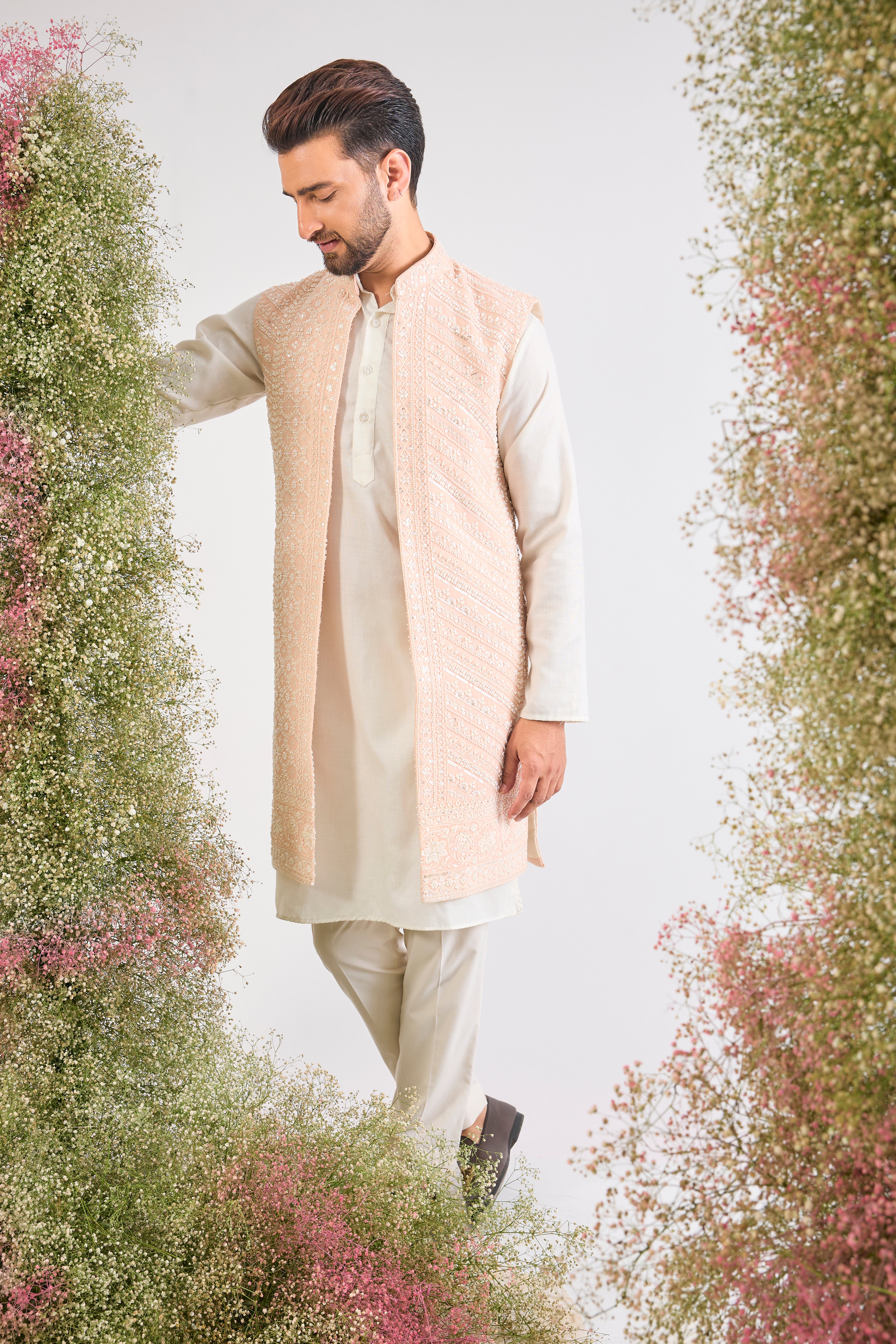 This stunning Pink Long Open Jacket is lavishly detailed with Intricate Hand Embroidered White Cut Dana work that catches the light beautifully.