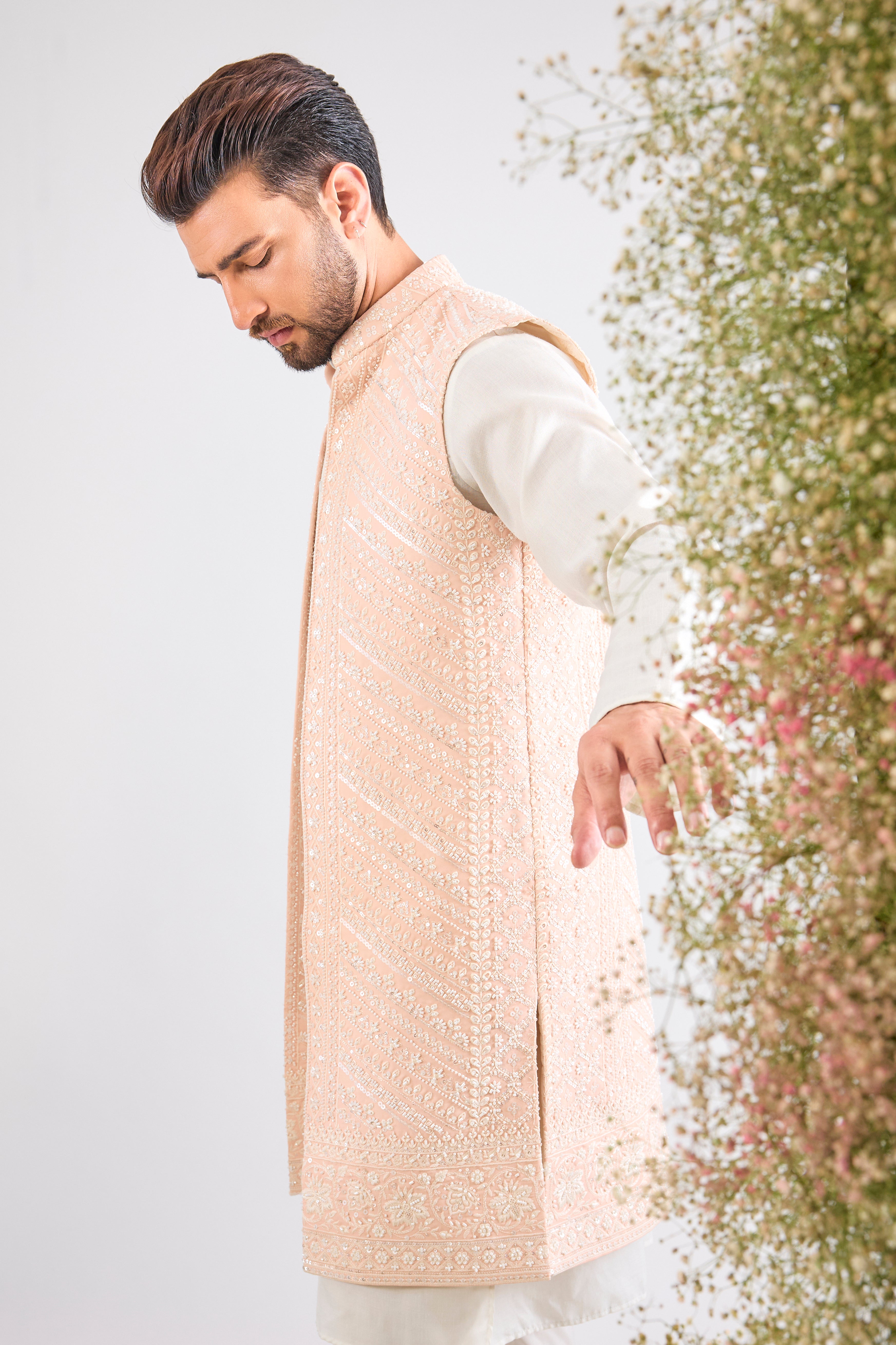 This stunning Pink Long Open Jacket is lavishly detailed with Intricate Hand Embroidered White Cut Dana work that catches the light beautifully.