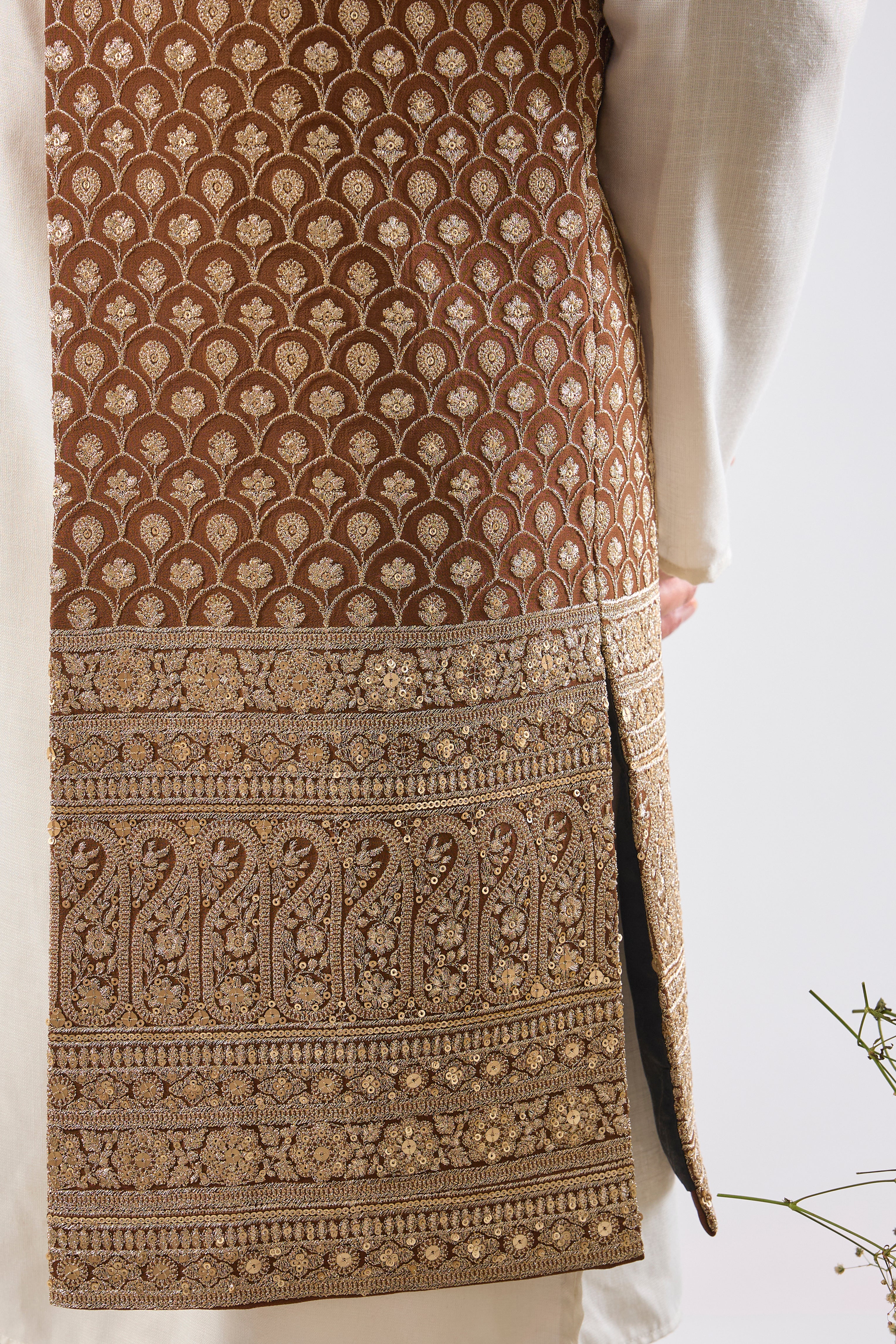 Deep, dazzling, and dramatic. Our Brown Ombre Long Open Jacket features breathtakingly Detailed Zari and Sequin Work. The perfect foundation for a royal entrance. 🤎