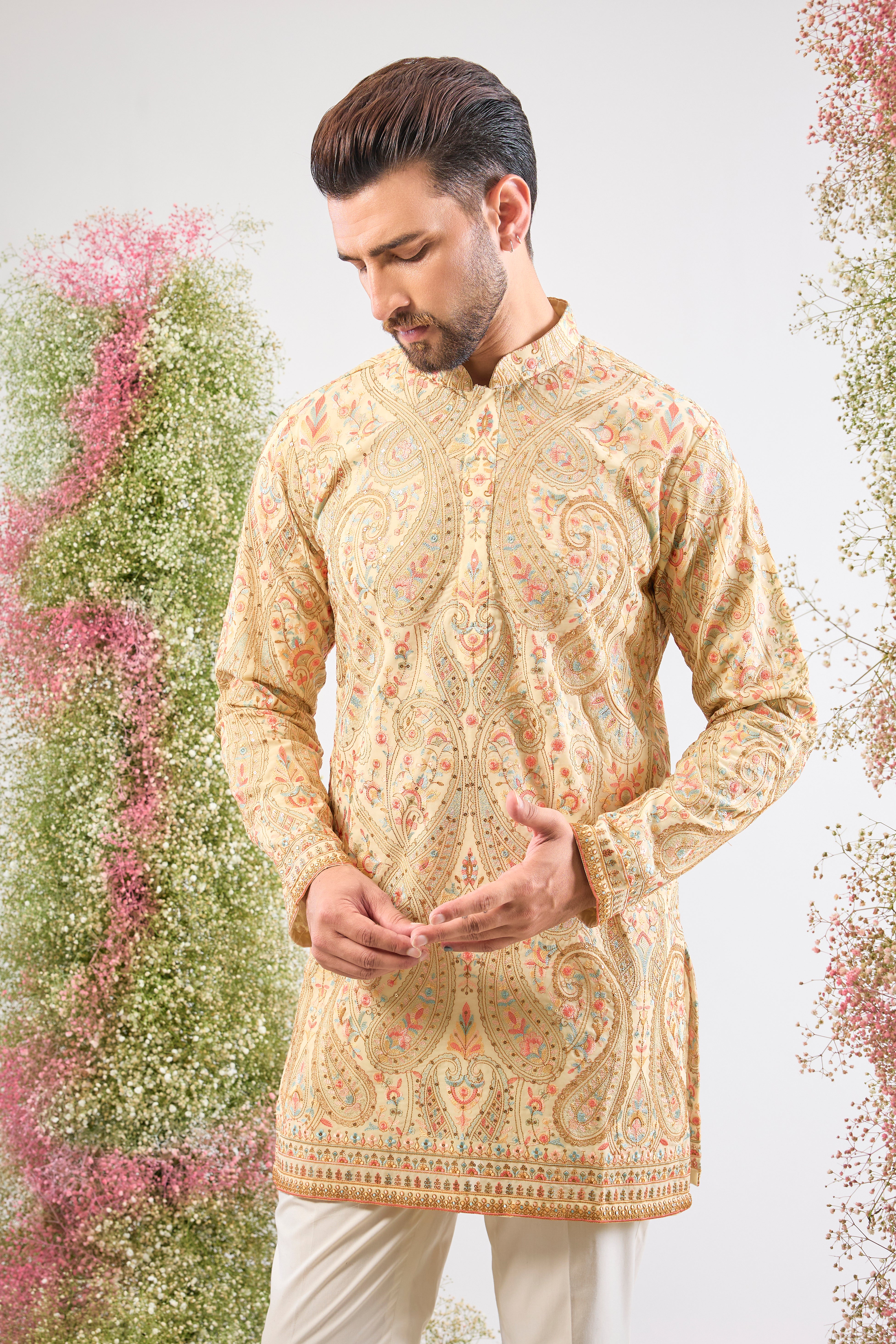 The perfect harmony of colour and craft! This Cream Kashmiri Embroidered Short Kurta showcases intricate patterns using a sophisticated blend of Multi-coloured Thread Work.