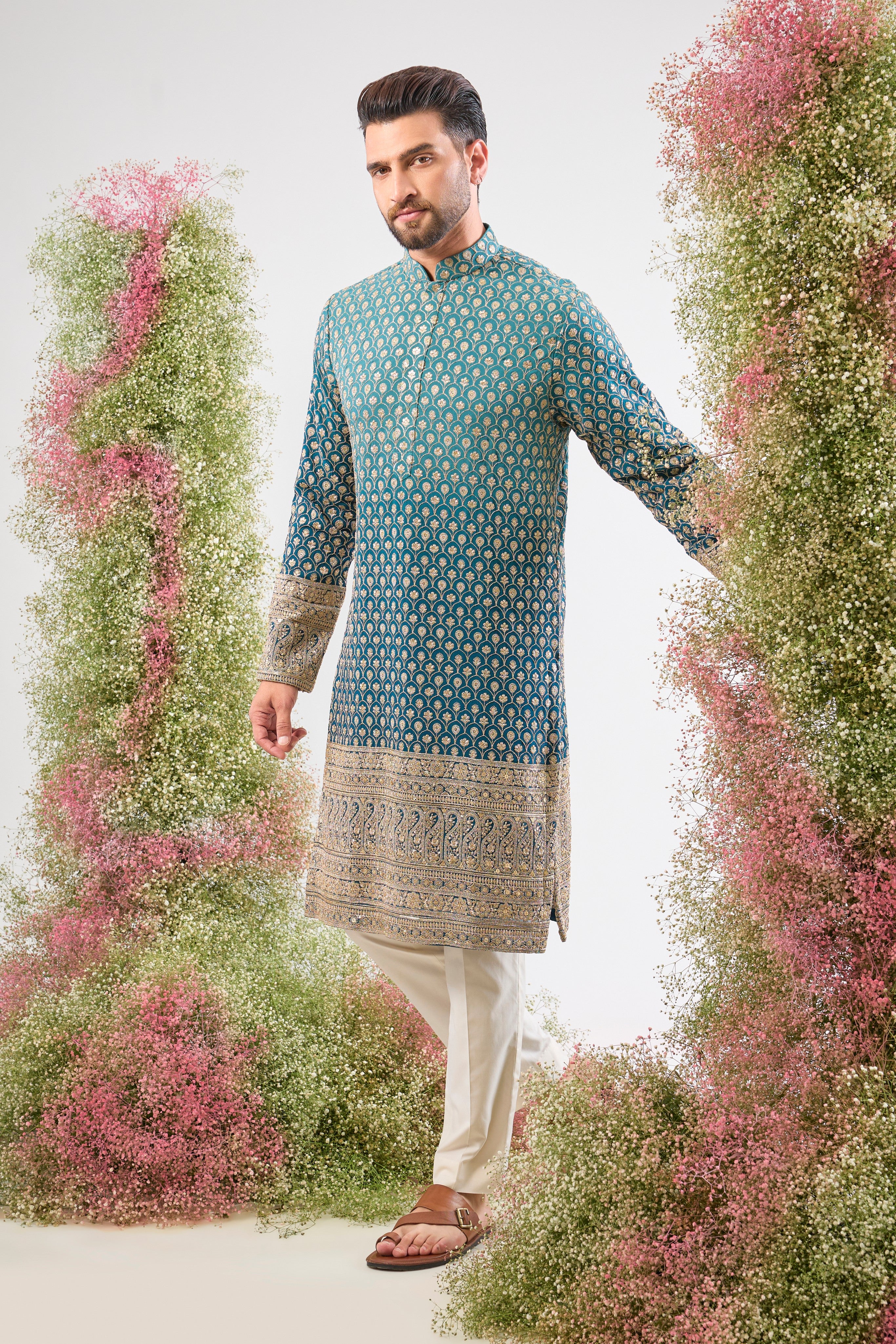 This Blue Ombre Shaded Kurta offers a stunning gradient effect, brought to life by the intense detailing of Intricate Zari and Sequin Work. The elegant, Heavy Ghera adds a traditional yet dramatic flair to your look. 👑