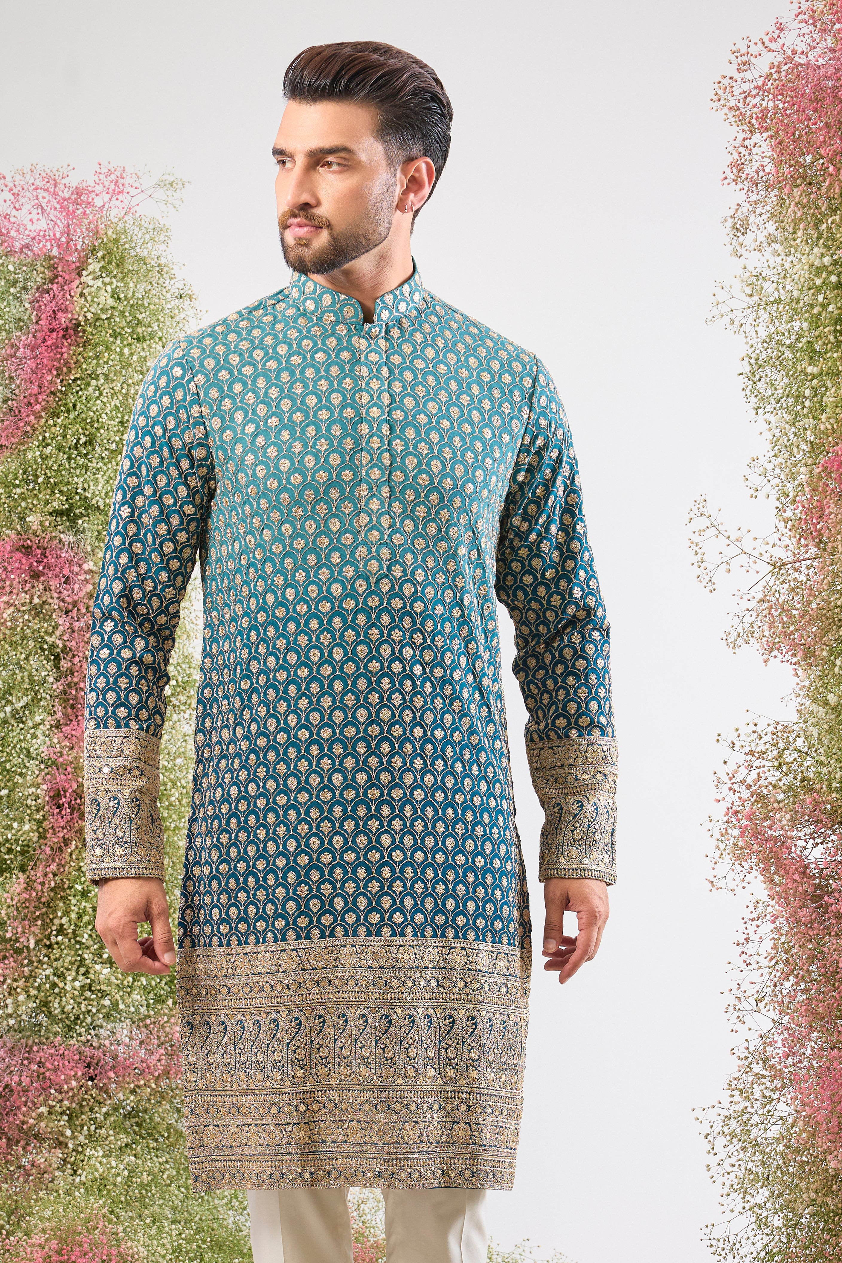 This Blue Ombre Shaded Kurta offers a stunning gradient effect, brought to life by the intense detailing of Intricate Zari and Sequin Work. The elegant, Heavy Ghera adds a traditional yet dramatic flair to your look. 👑