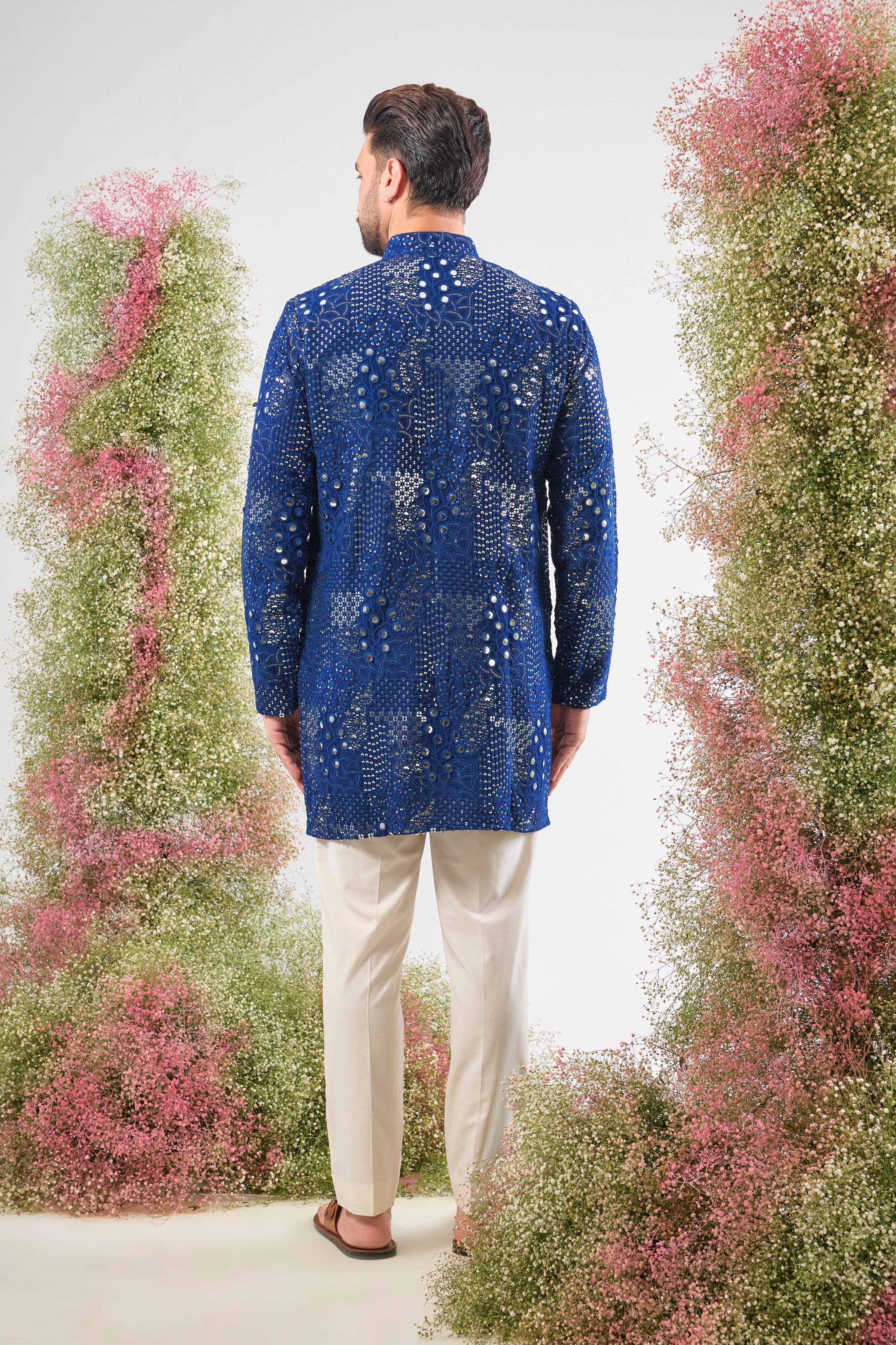A harmonious blend of craft and colour. This bright Blue Mirror Work Kurta showcases Tone-to-Tone Thread Work and stunning Intricate Floral Patterns, all illuminated by sparkling sequin detailing.