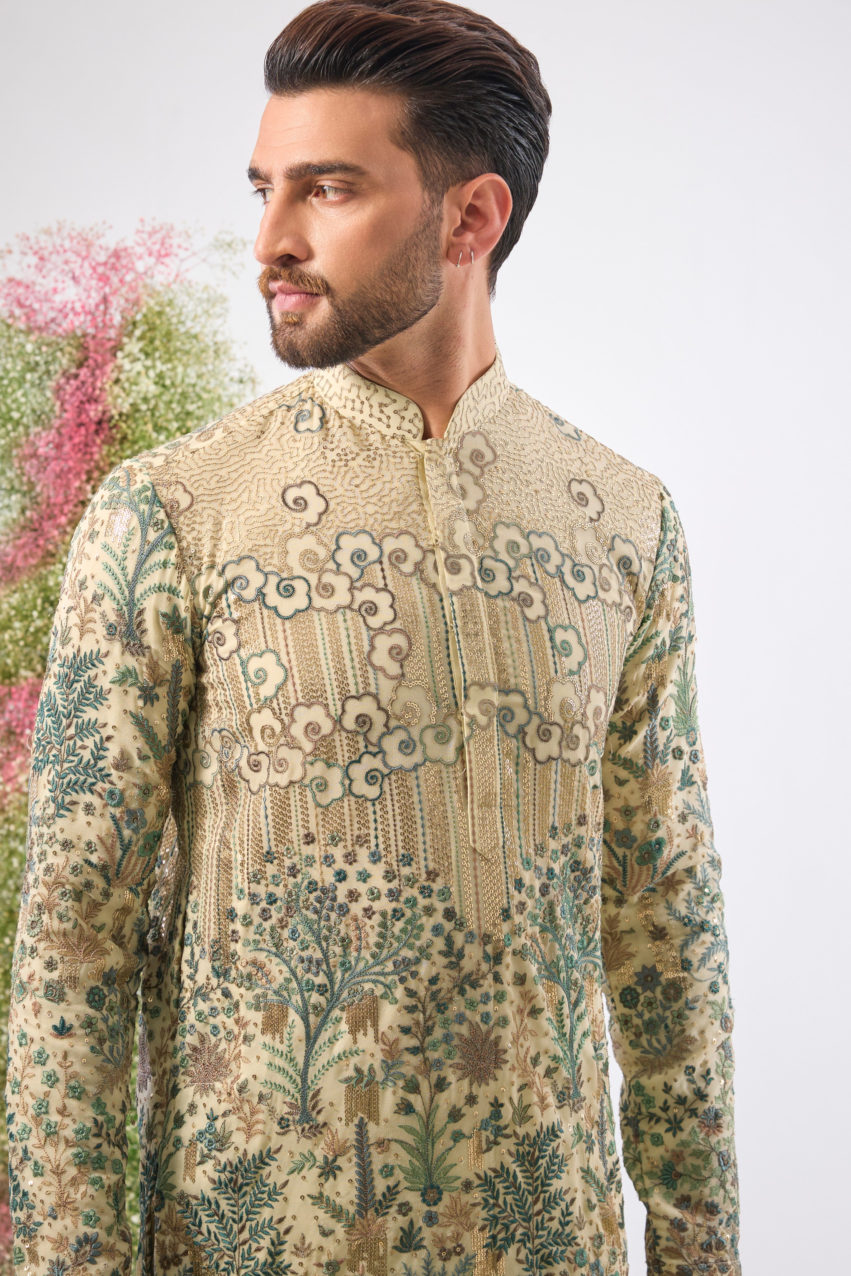 Wear a piece of art. This breathtaking Ivory Cream Kurta features a Detailed Floral Tropical Era design, showcasing intricate artistry in Green and Cream Threadwork.