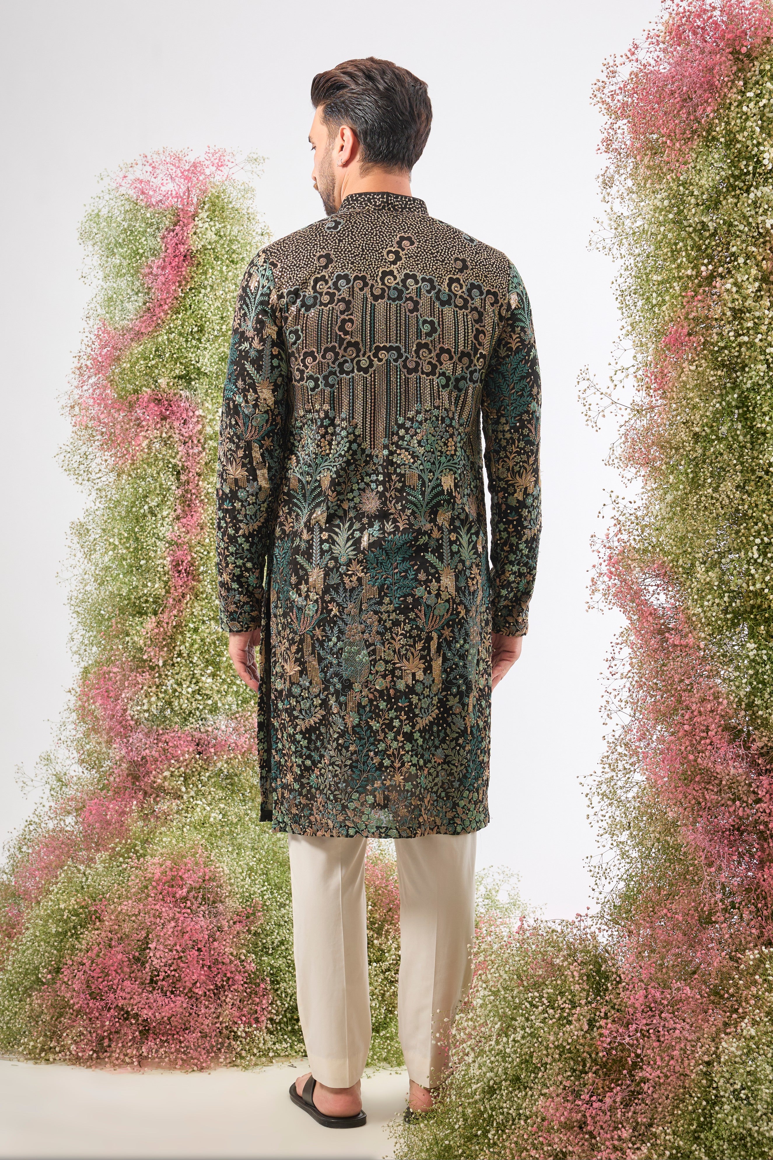 Wear a piece of dark art. This breathtaking Black Kurta features a Detailed Floral Tropical Era design, showcasing intricate artistry in Green and Black Threadwork.