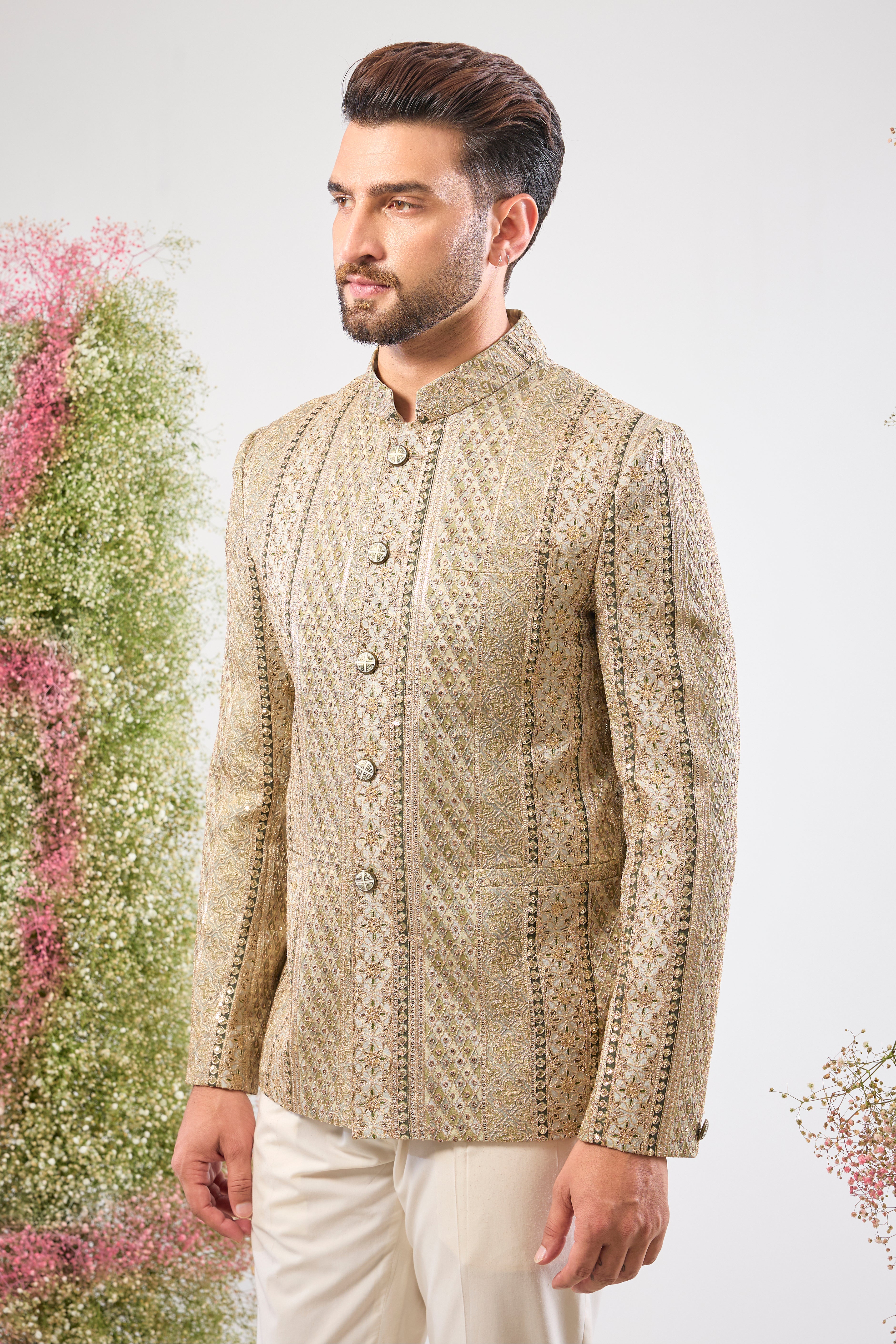 This Sage Green Bandhgala showcases rich Detailed Zari Work across the fabric, complemented by glittering sequin accents. The Classy Metal Buttons provide a sharp, polished finish to this exceptionally handsome jacket.