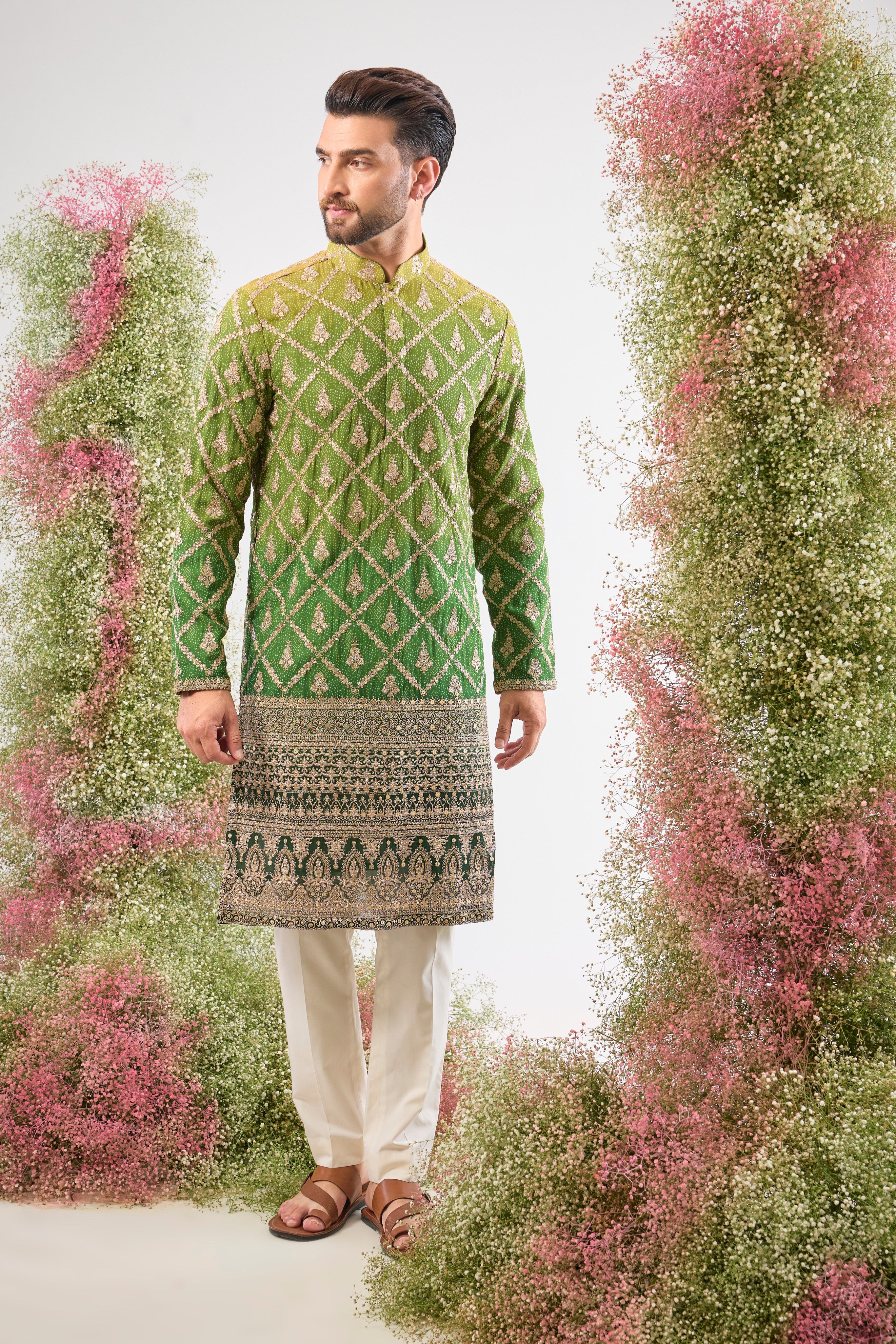 This Long Kurta in Bandhani Print features an exceptionally rich Heavy Zari Work Border and sparkling sequin detailing. The full length and dense embroidery create a truly majestic look.