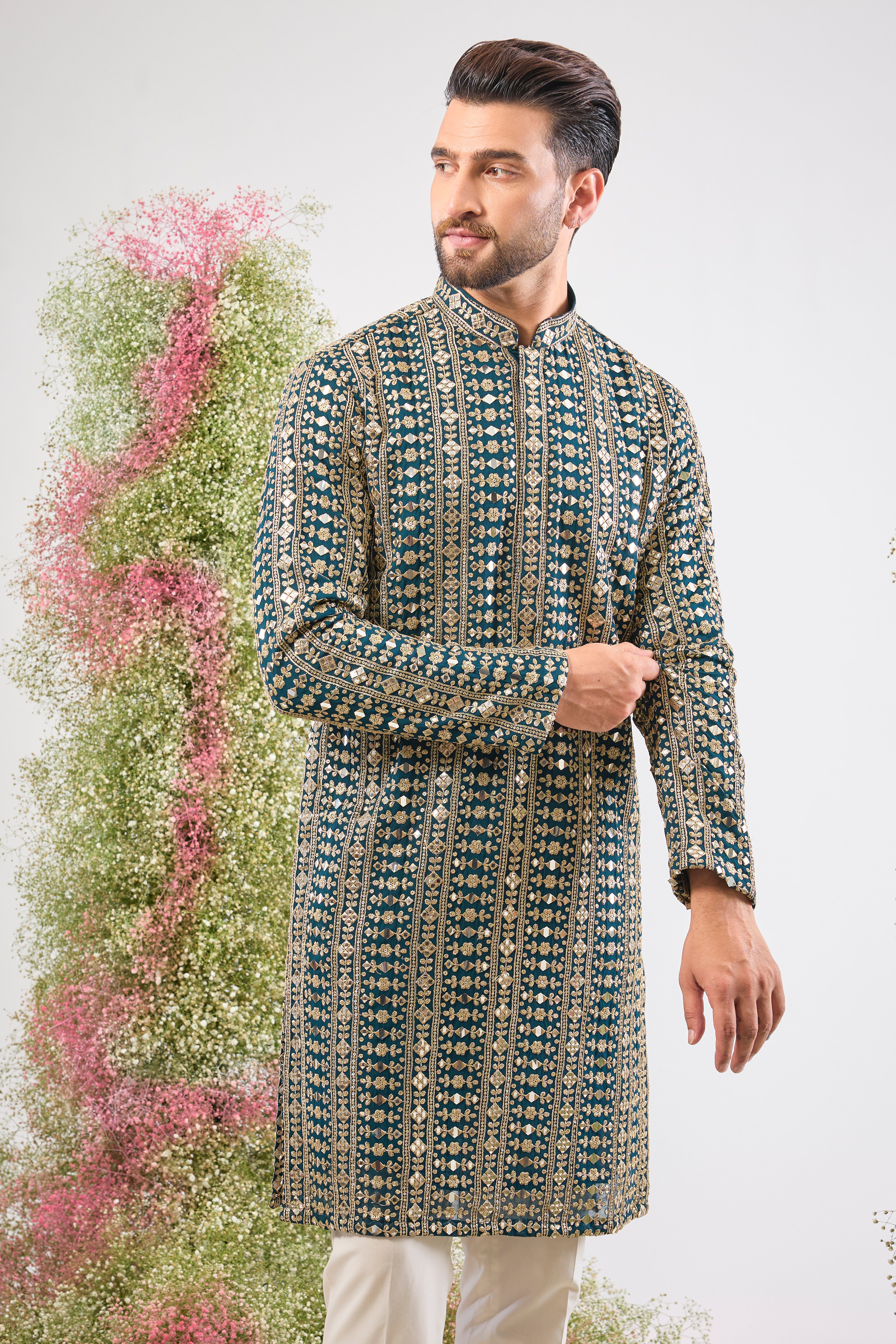 This Mirror Work Kurta showcases the grandeur of Heavy Zari and Sequin Work, providing unmatched brilliance and texture. The stunning colour and dense handwork create an aura of sophisticated festive luxury.