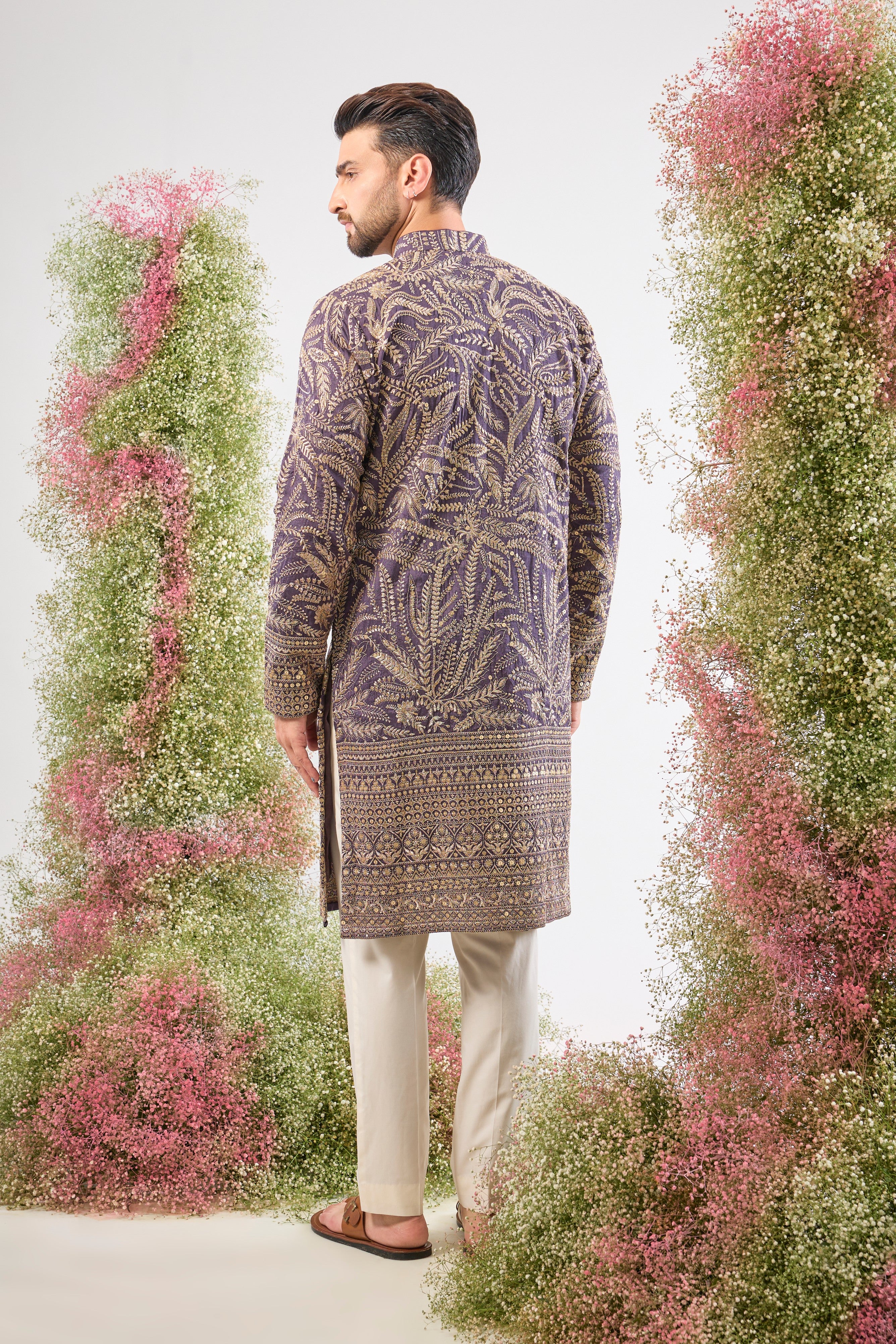 This Purple Mauve Long Zari Kurta is adorned with exquisite Detailed Floral Embroidery and shimmering sequins, creating incredible texture. The Heavy Ghera adds a dramatic, flowing elegance to the long silhouette.