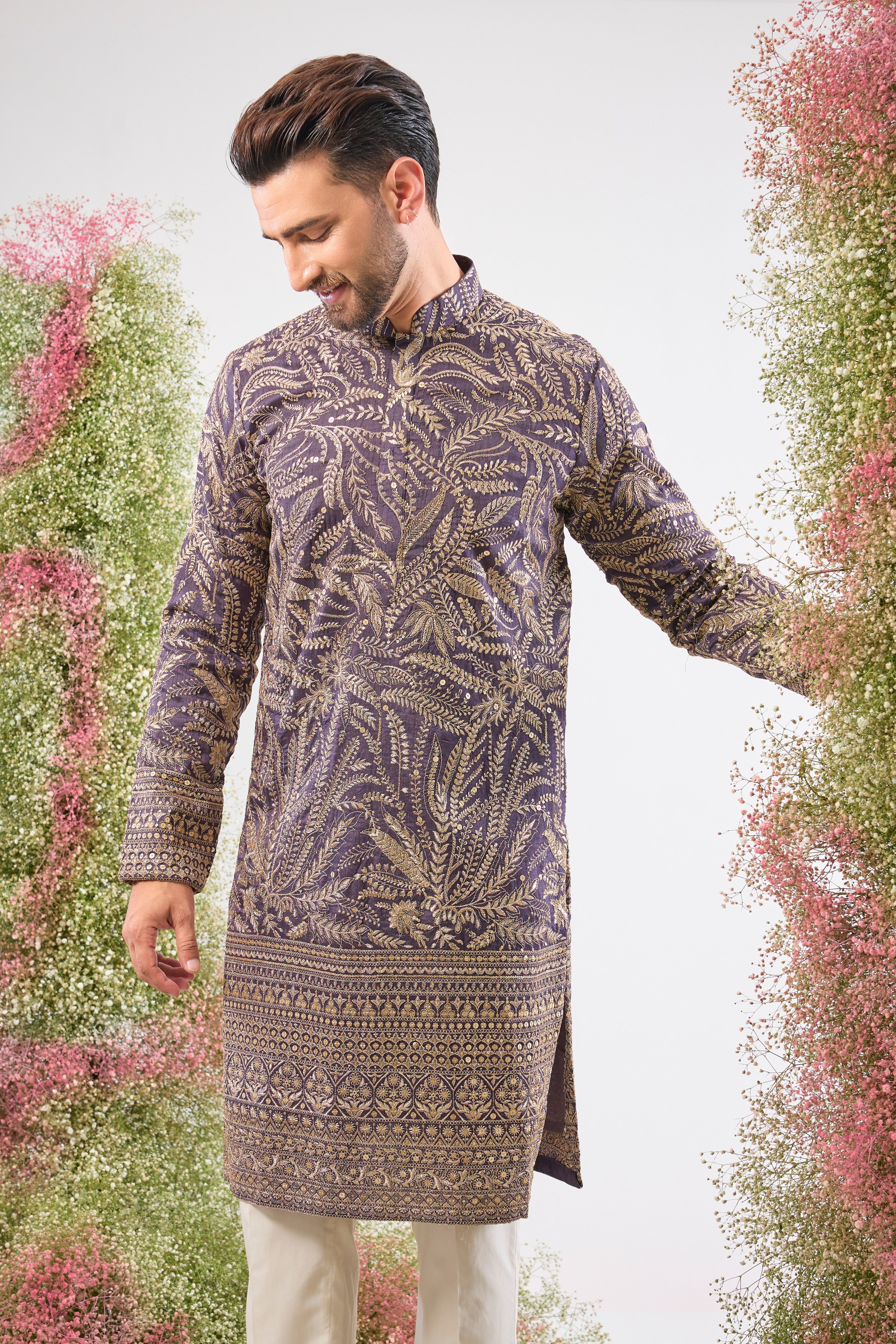 This Purple Mauve Long Zari Kurta is adorned with exquisite Detailed Floral Embroidery and shimmering sequins, creating incredible texture. The Heavy Ghera adds a dramatic, flowing elegance to the long silhouette.