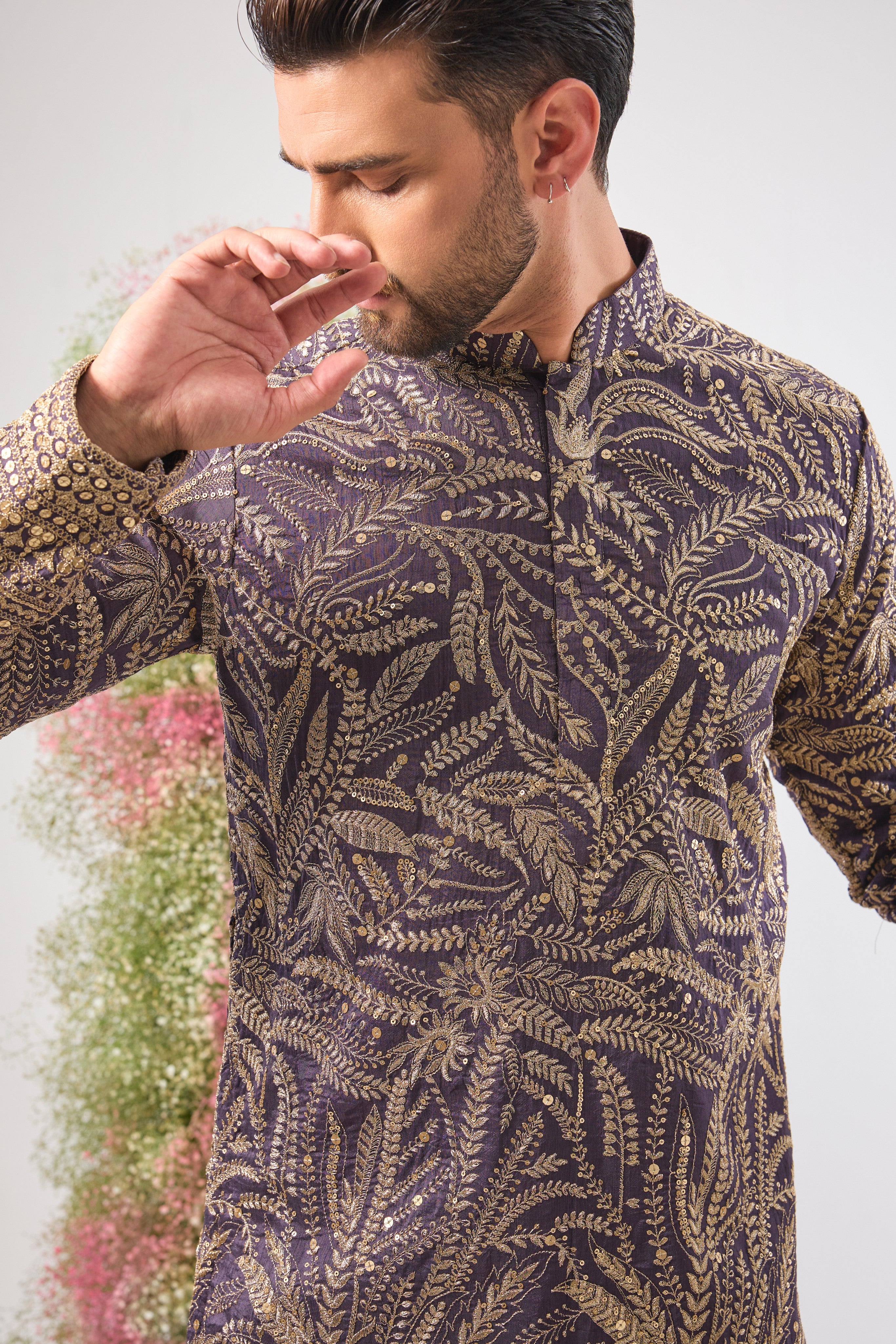 This Purple Mauve Long Zari Kurta is adorned with exquisite Detailed Floral Embroidery and shimmering sequins, creating incredible texture. The Heavy Ghera adds a dramatic, flowing elegance to the long silhouette.