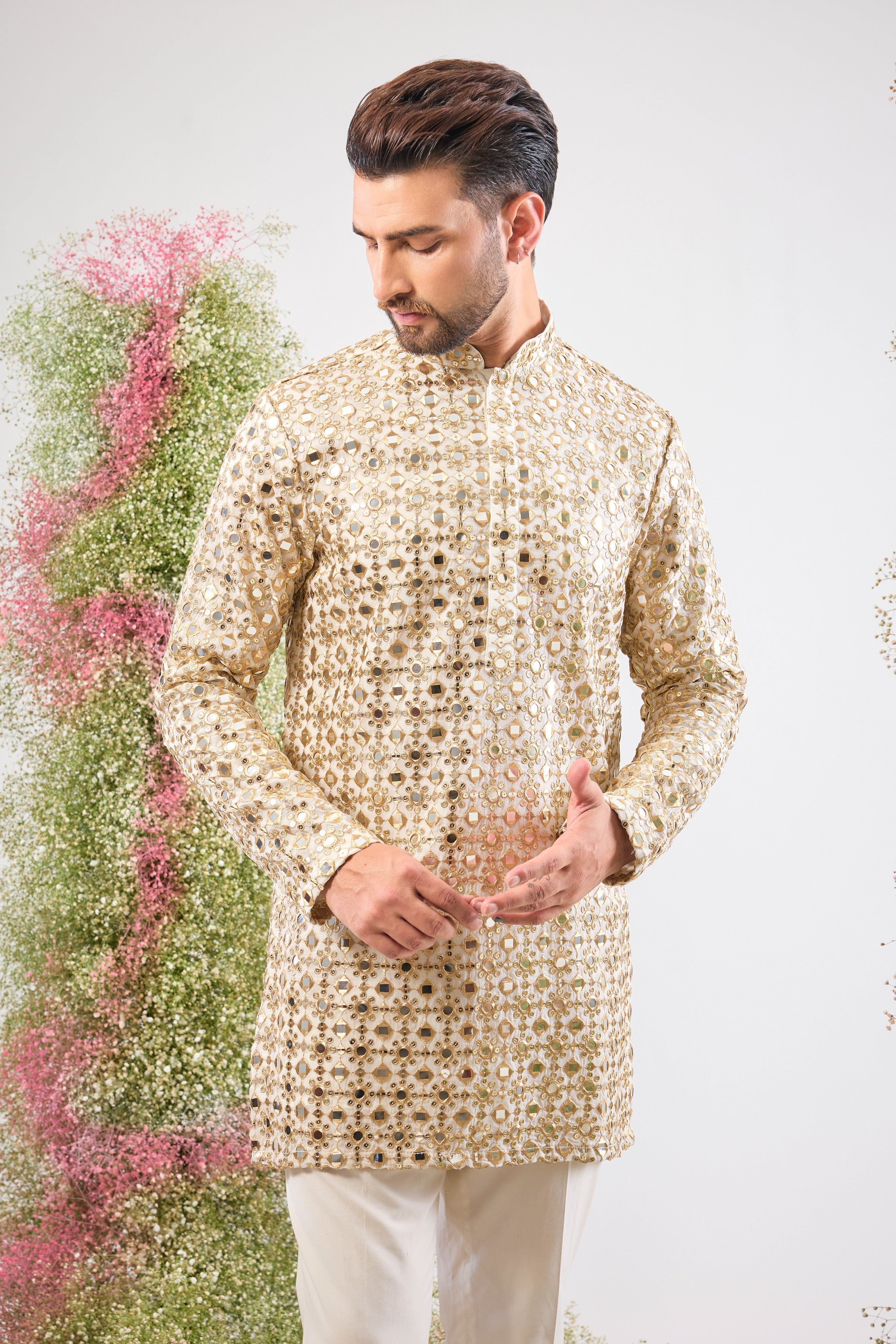 This White Short Mirror Work Kurta showcases the richness of Heavy Zari Work, providing unmatched texture and depth. The intensive sequin detailing guarantees a luminous, show-stopping look.