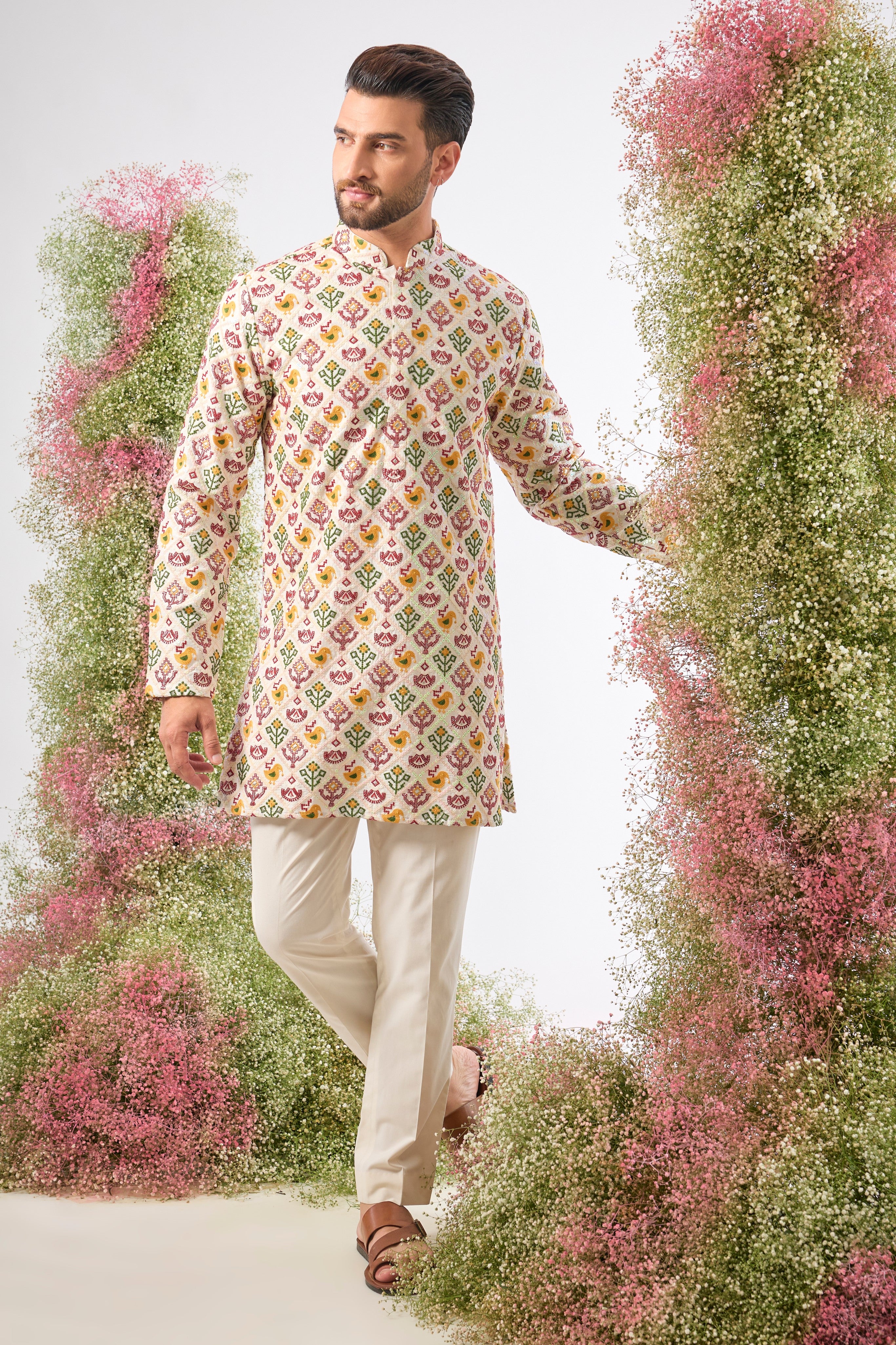his White Short Kurta showcases the stunning geometric patterns of Phulkari Embroidery using a rich array of Multi-coloured Threads. The subtle sequin detailing adds a perfect touch of festive shimmer.