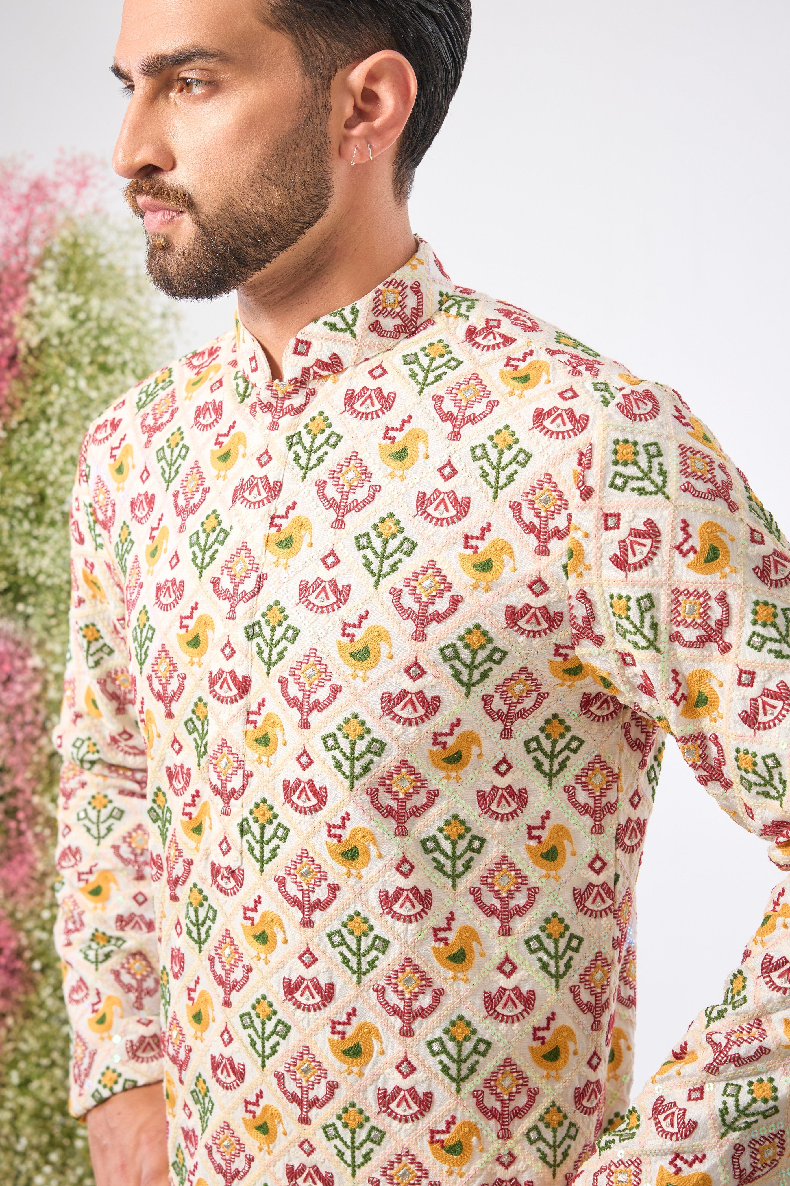 his White Short Kurta showcases the stunning geometric patterns of Phulkari Embroidery using a rich array of Multi-coloured Threads. The subtle sequin detailing adds a perfect touch of festive shimmer.