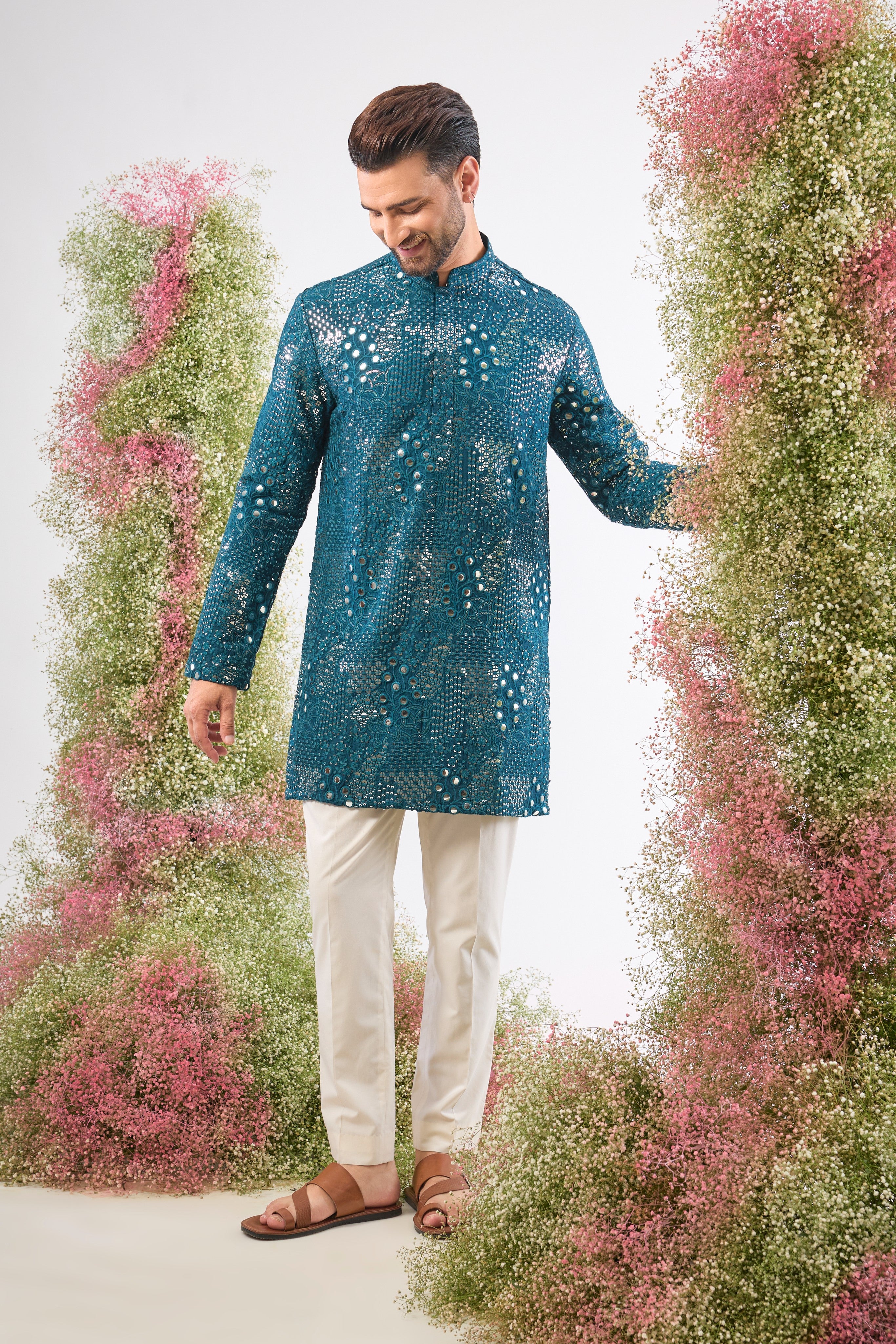 This Teal Mirror Work Kurta showcases exquisite Intricate Floral Patterns, beautifully highlighted by the reflective Sequin Work. The combination creates depth, vibrancy, and a continuous, captivating shimmer.