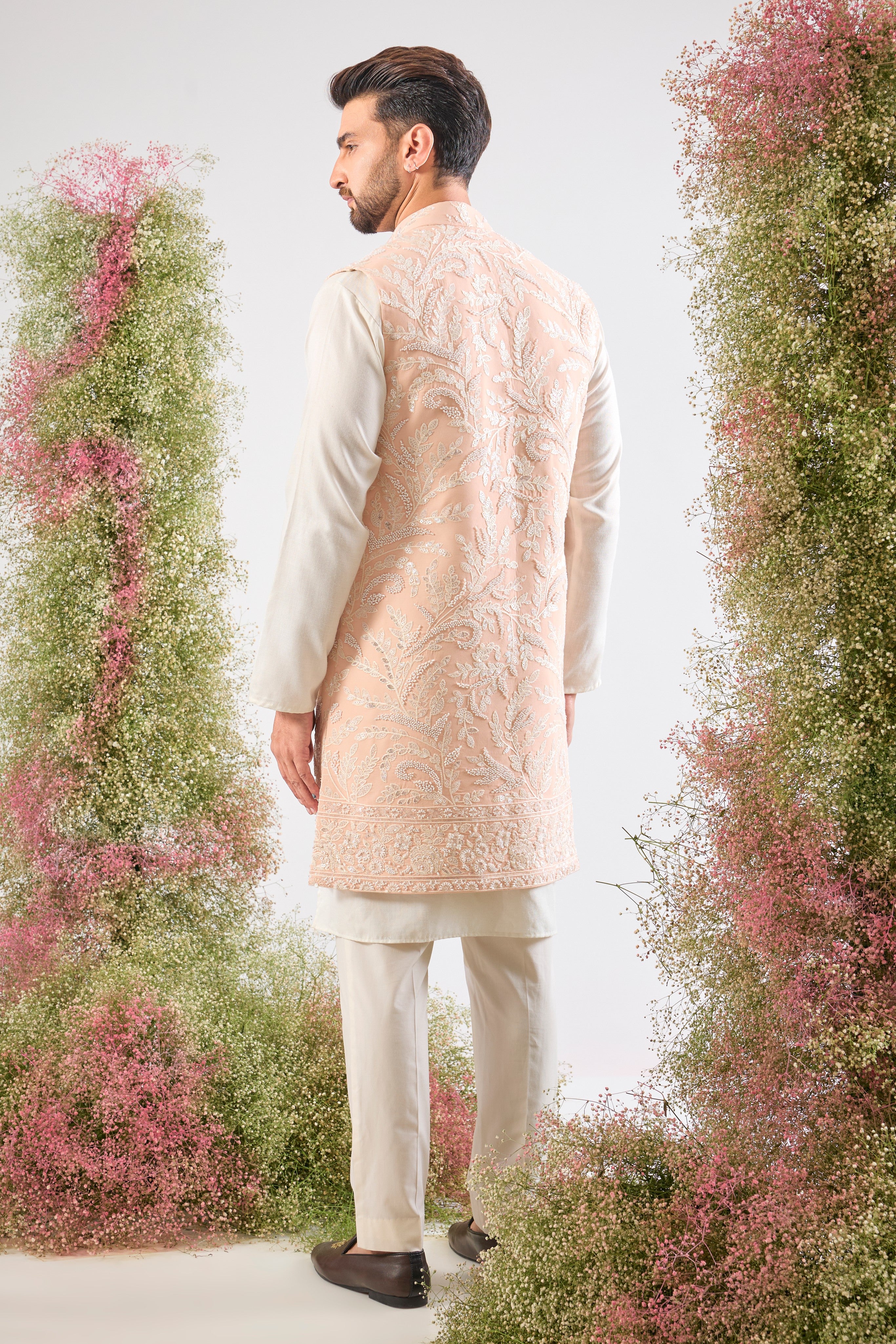 Handcrafted perfection. Our Long Open Jacket features detailed Hind Hand Work, luminous White Cut Dana, sequins, and a delicate Floral Pattern. Pure elegance.