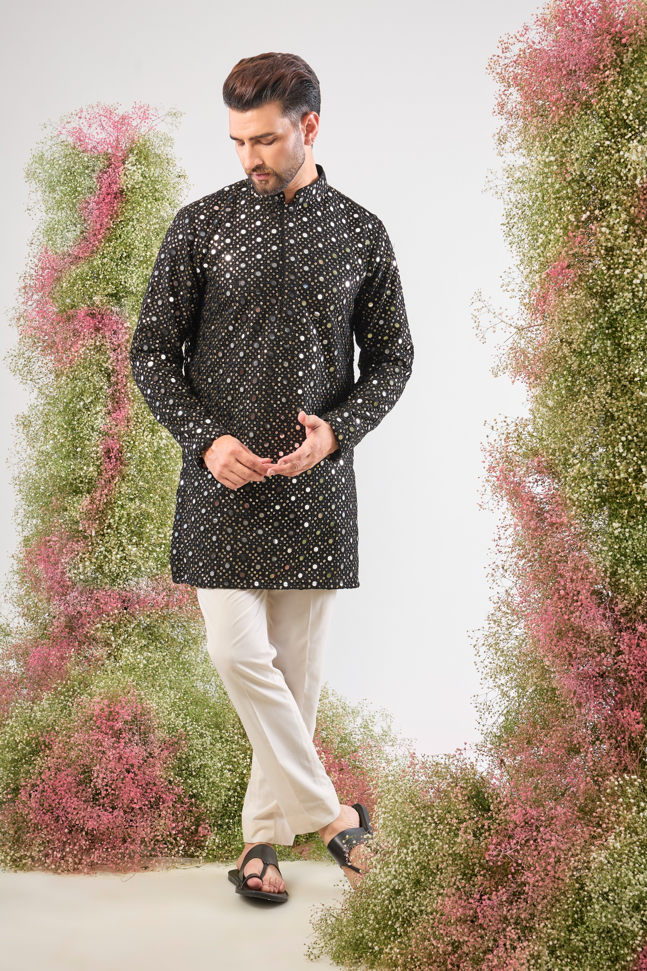 This Short Mirror Work Kurta showcases the richness of a dark base illuminated by continuous, Heavy Sequin Work. The dense sequin coverage ensures a luminous, unforgettable texture, making it the definition of sophisticated party wear.