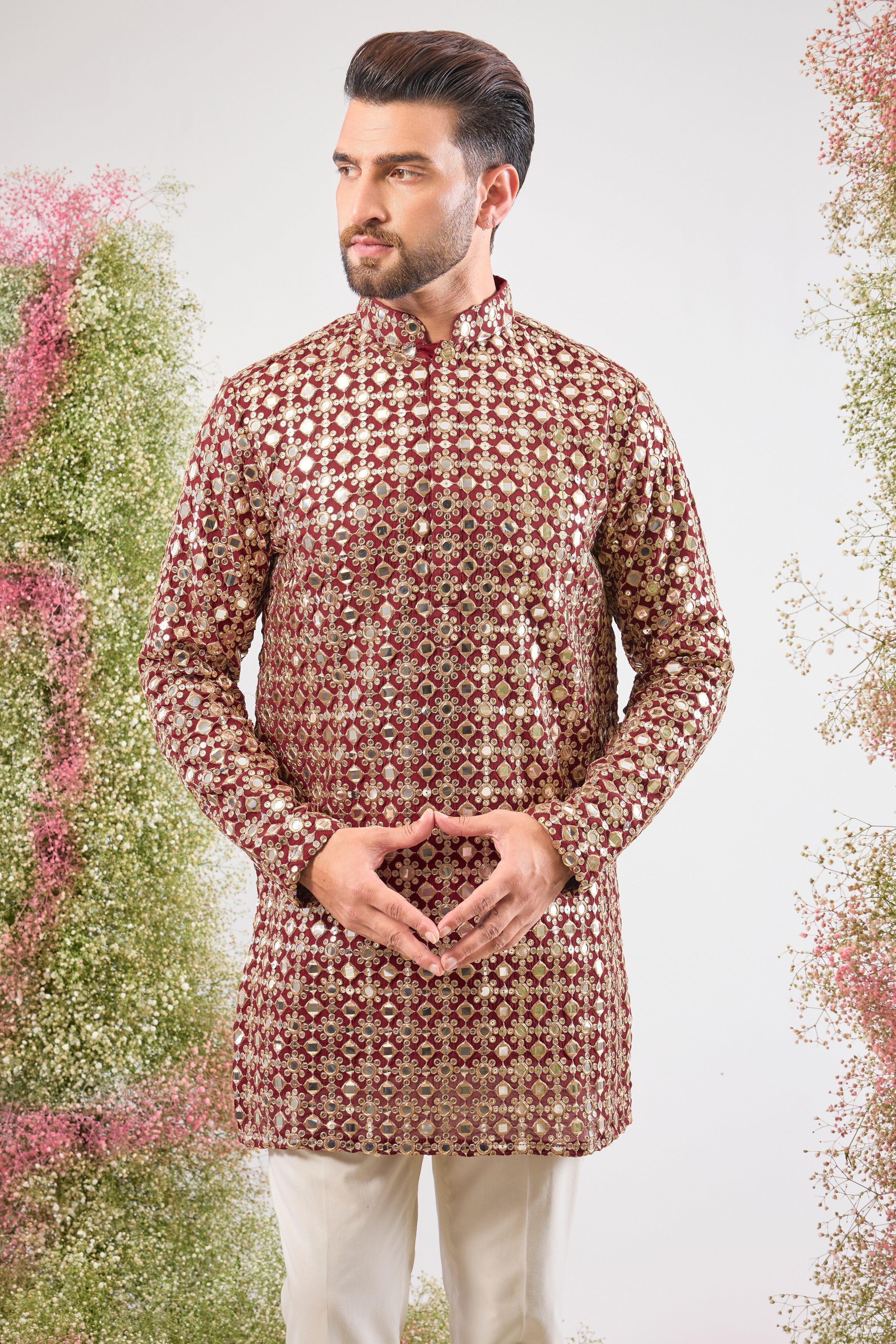 This Maroon Mirror Work Short Kurta showcases the dramatic texture of Heavy Zari Work, seamlessly blended with the brilliant shimmer of Detailed Sequins. The result is a garment that offers unmatched depth and sparkle, capturing light beautifully.