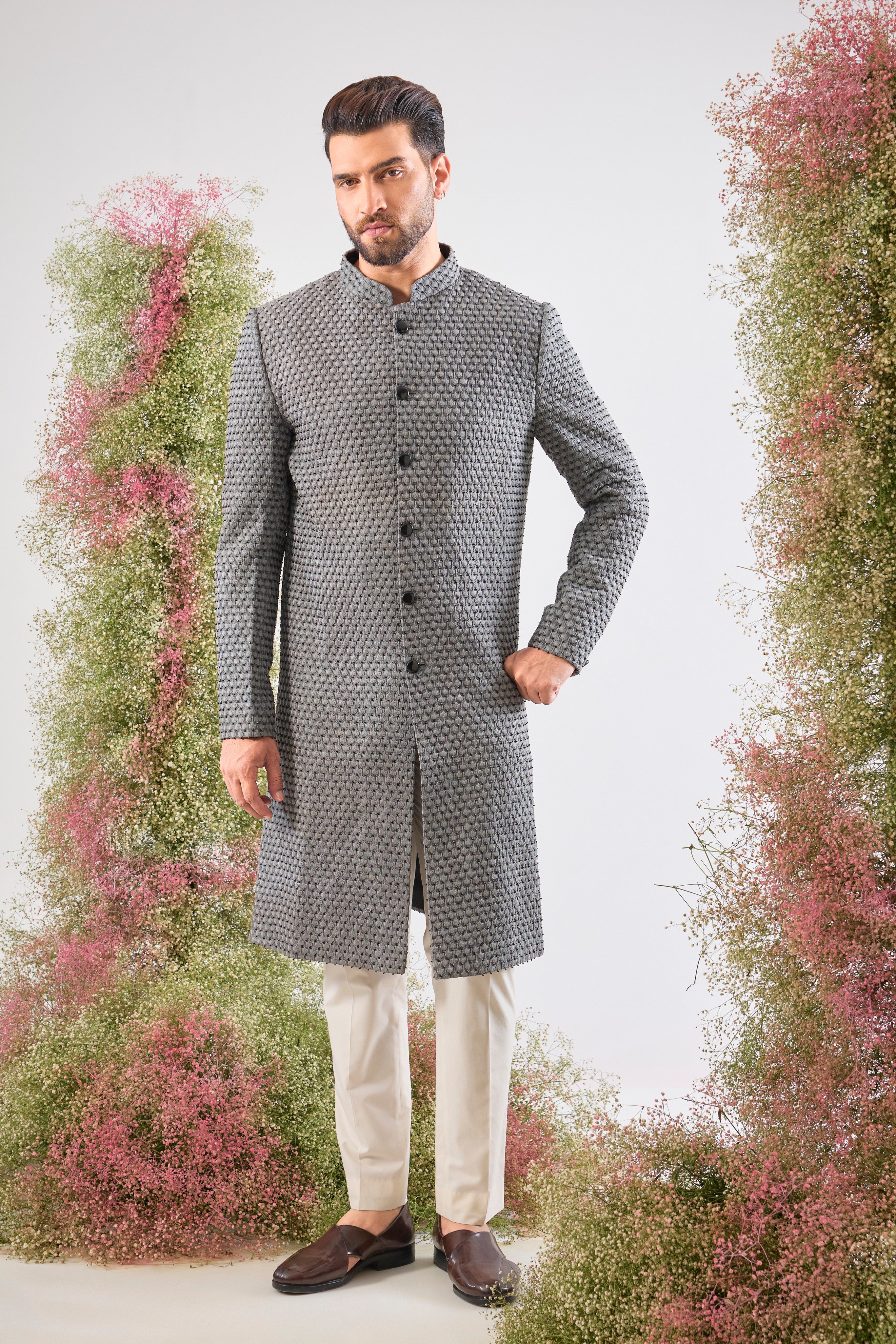 This Sherwani is a masterpiece of design, showcasing the density of Heavy Thread Work layered with the brilliant reflection of Black Cut Dana.