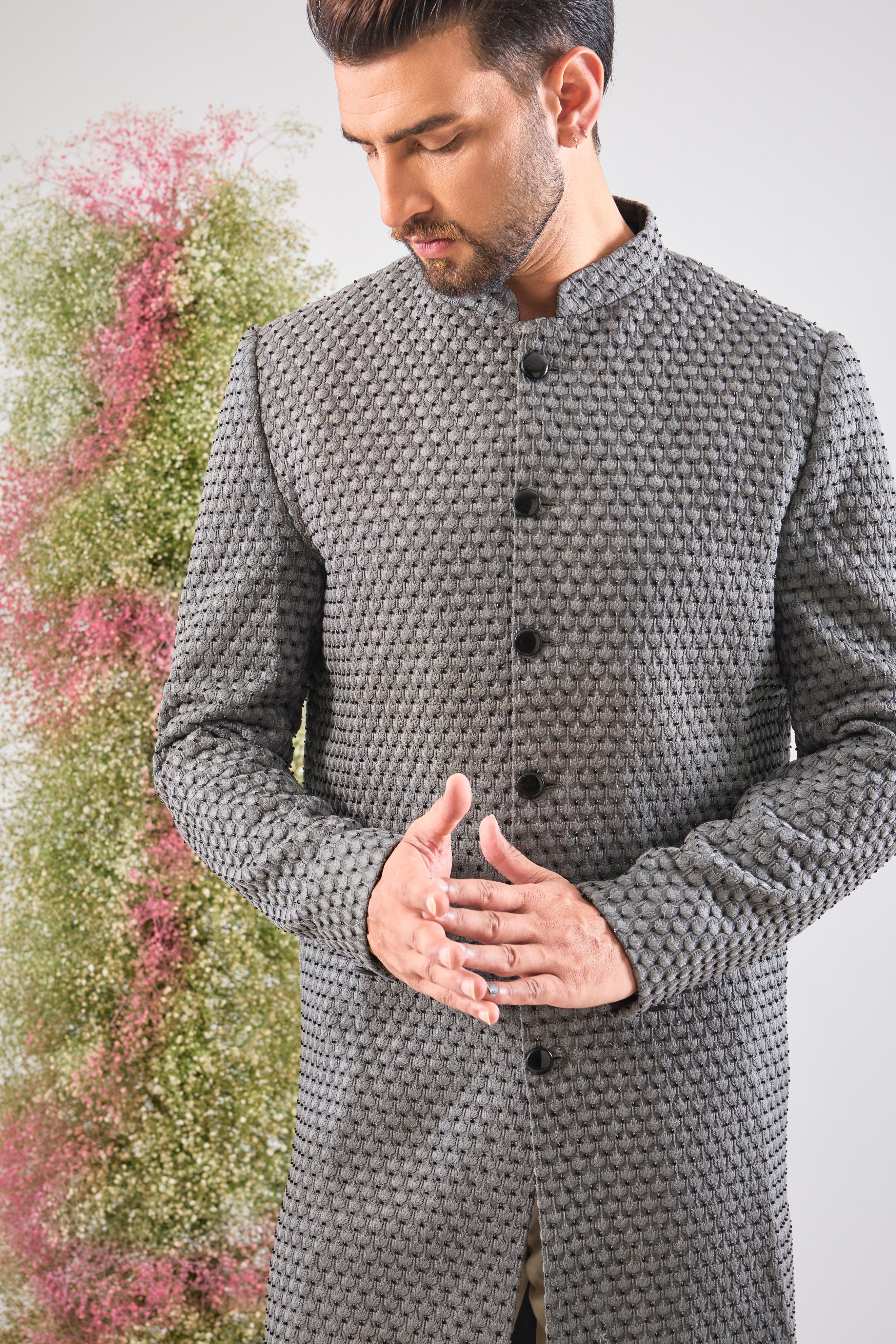 This Sherwani is a masterpiece of design, showcasing the density of Heavy Thread Work layered with the brilliant reflection of Black Cut Dana.