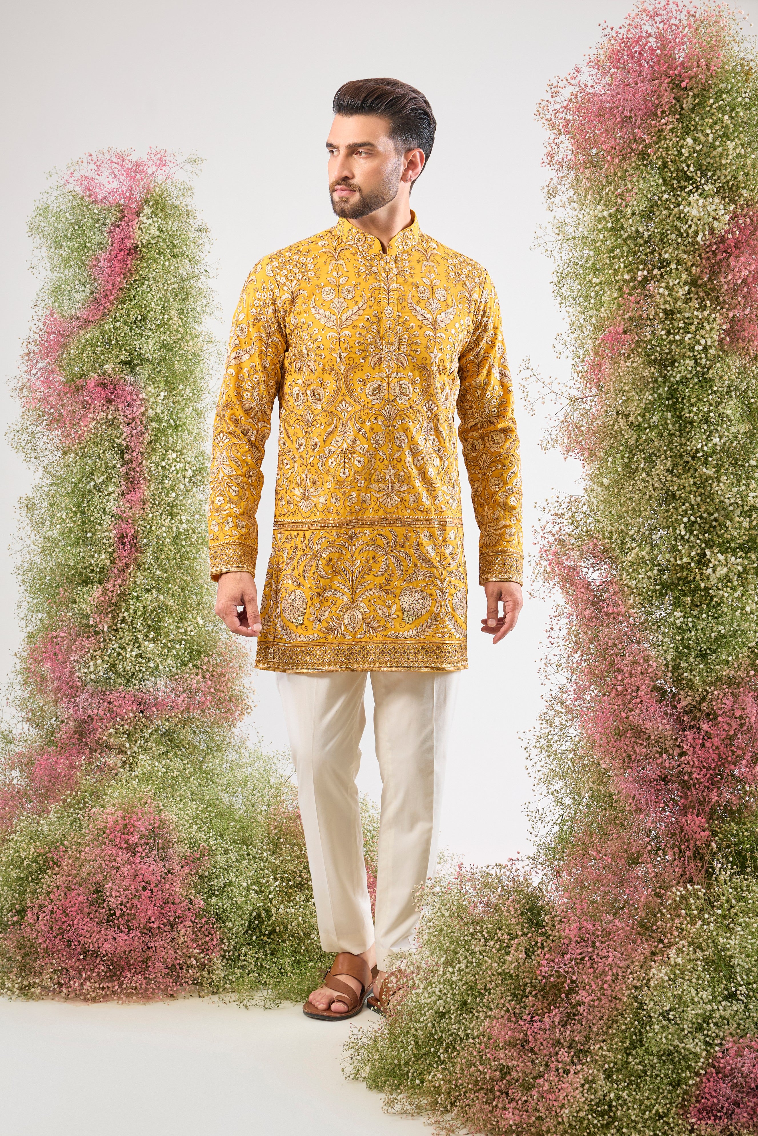 This Yellow Short Kurta is a masterpiece of texture, showcasing Heavy Zari Work layered with sparkling Sequins and rich Detailed Floral Embroidery. The dense handwork creates an opulent look, perfectly balancing vibrancy and sophistication.