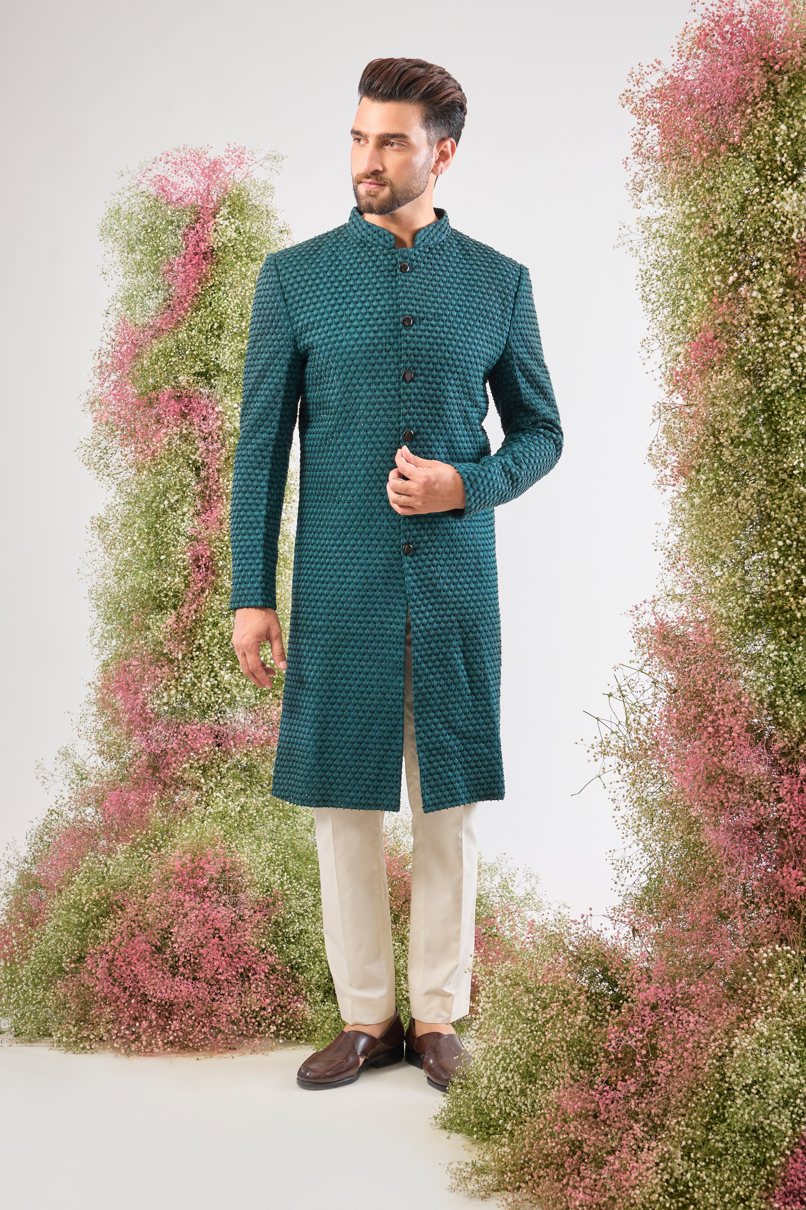 This Sherwani is lavishly detailed with Heavy Thread Work layered with the striking contrast of Black Cut Dana, offering both depth and subtle sparkle.