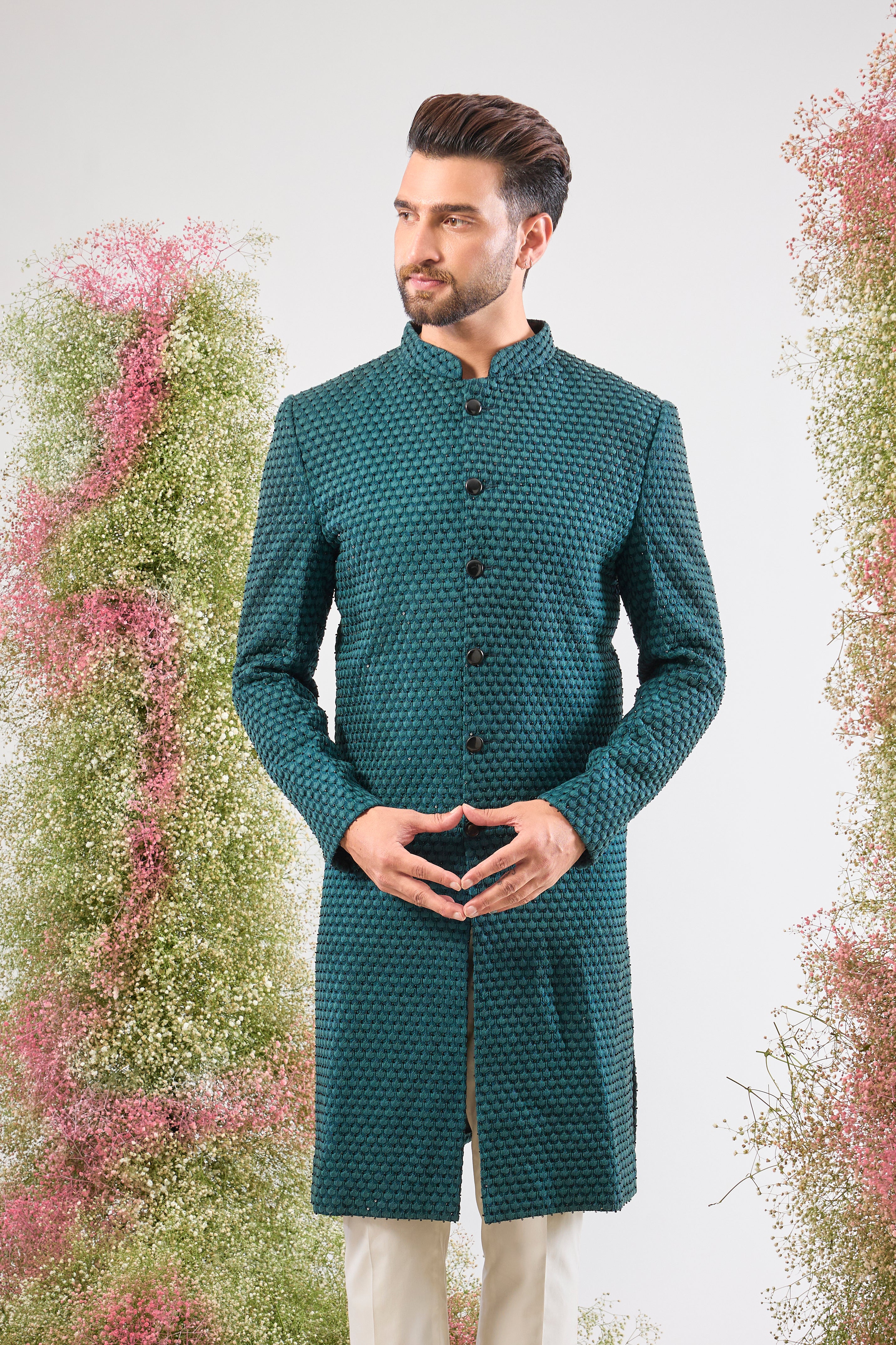 This Sherwani is lavishly detailed with Heavy Thread Work layered with the striking contrast of Black Cut Dana, offering both depth and subtle sparkle.